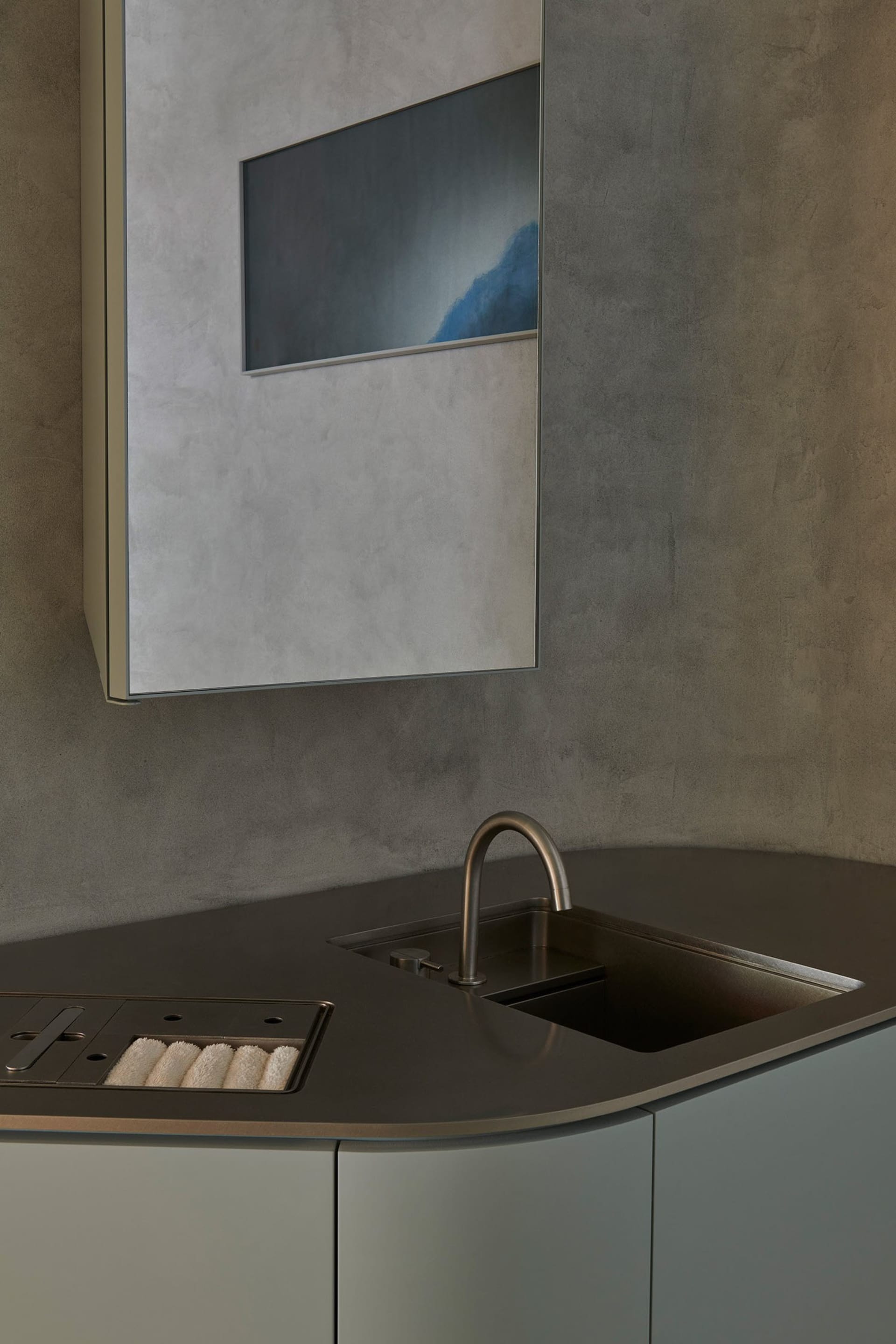 Modern kitchen featuring a concrete countertop and minimalist design.