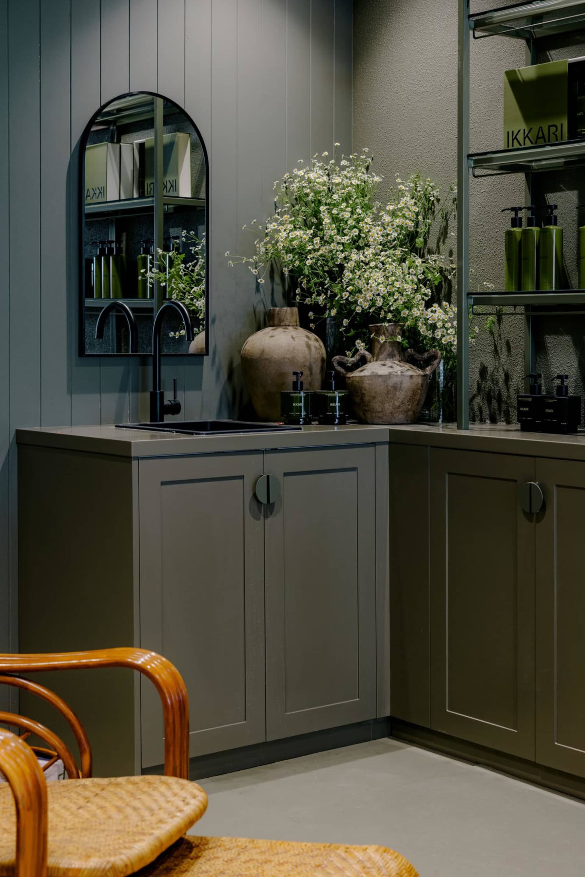 Modern kitchen featuring metallic-textured cabinets and a sink with olive green walls
