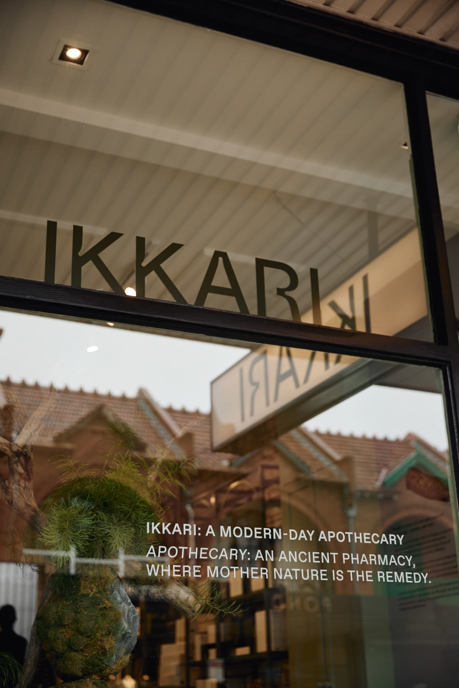 Glass storefront window displaying the word 'Ikkari' and the description of the store's nature.