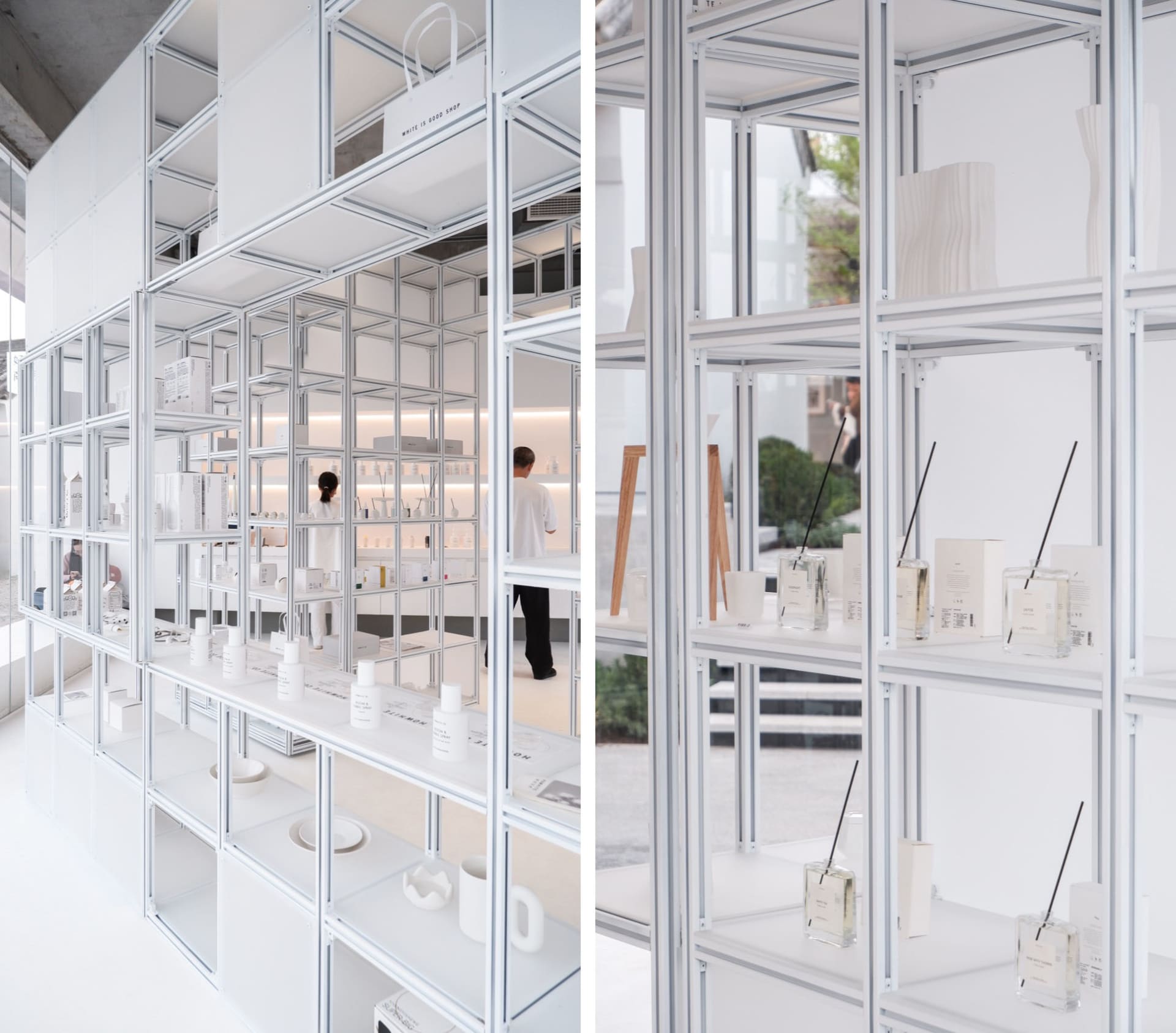 Modern white steel shelves with transparent glass divisions in a retail storefront.