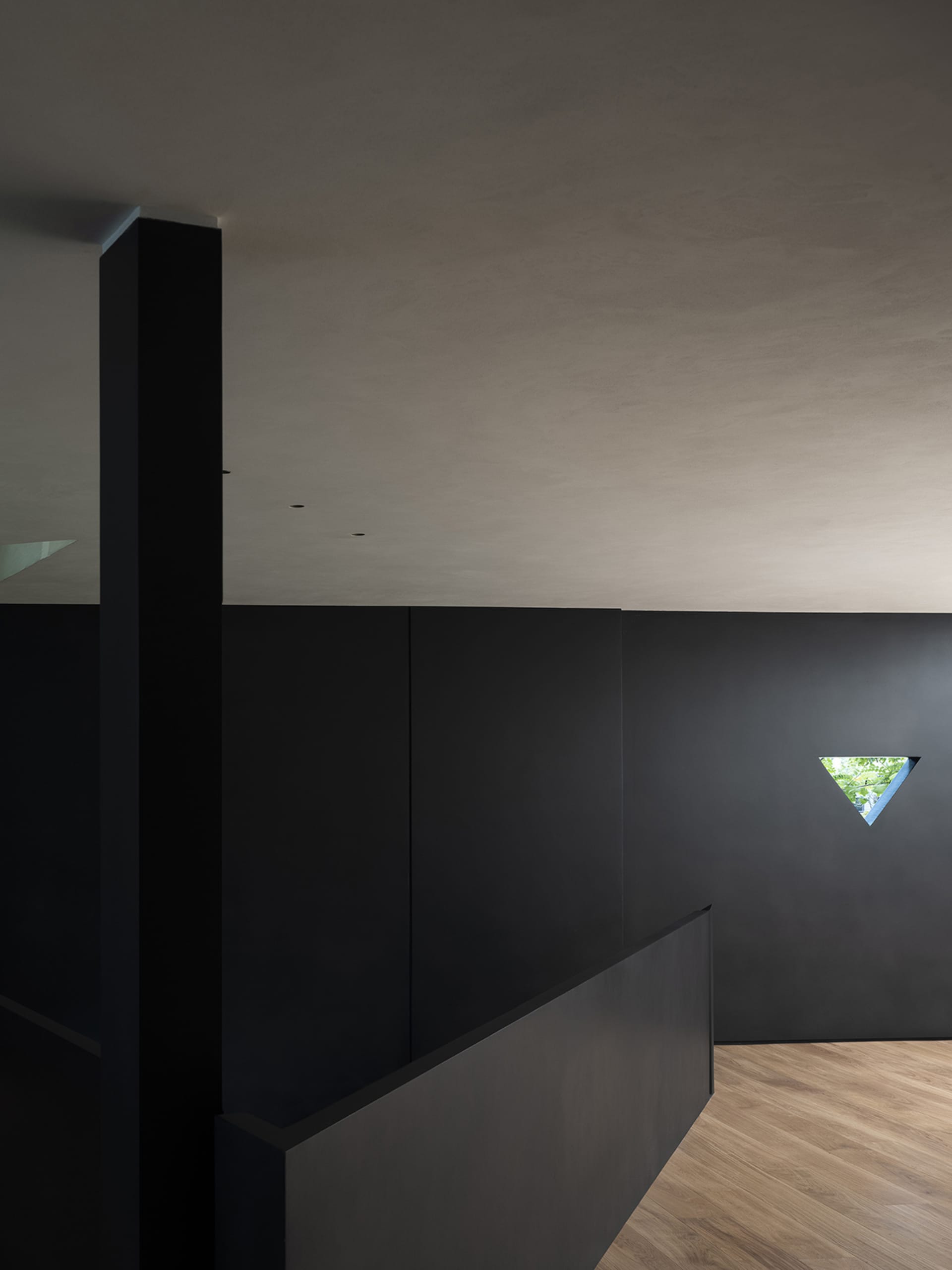 A minimalist black interior with a metallic window