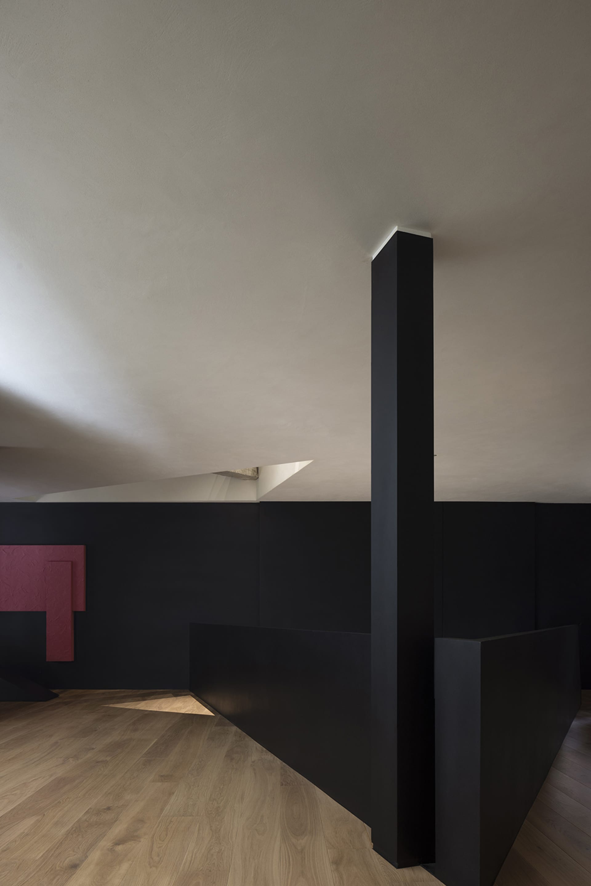 A modern interior space featuring concrete walls, minimalist design, and geometric shapes.
