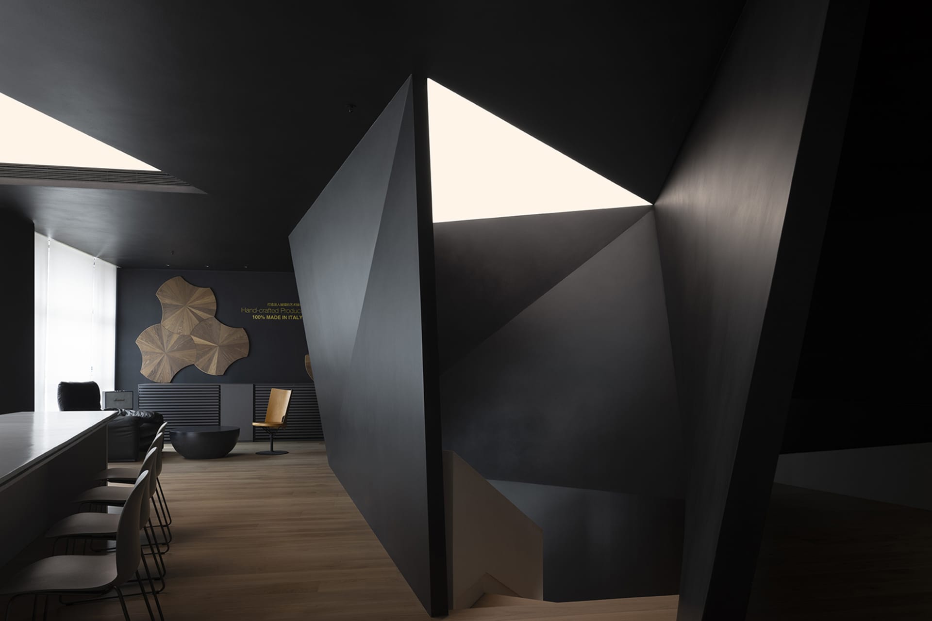 An office space featuring a contemporary design with dark metallic elements.