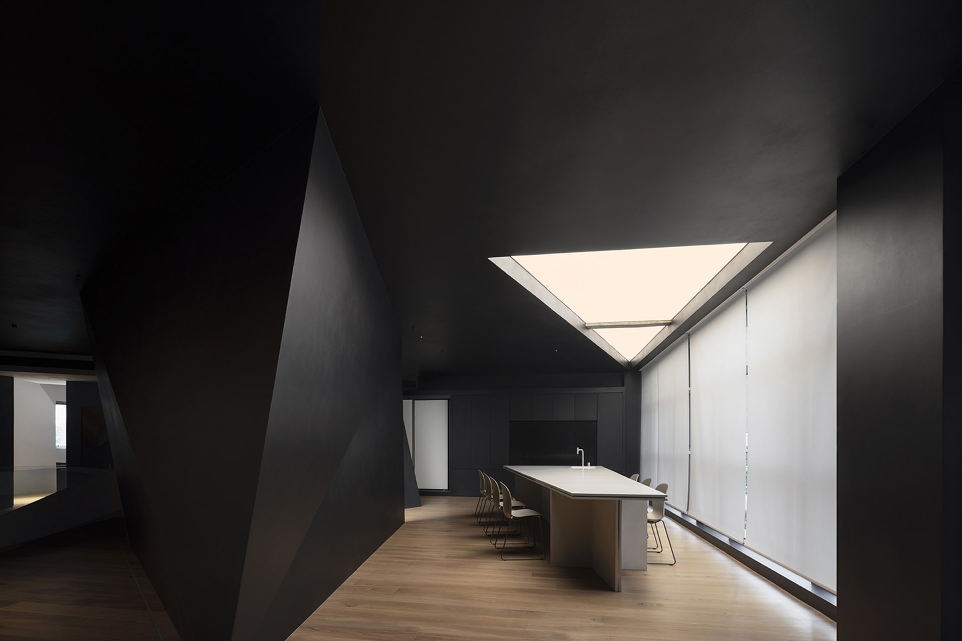 A modern office featuring glass walls and a sleek, minimalist design.