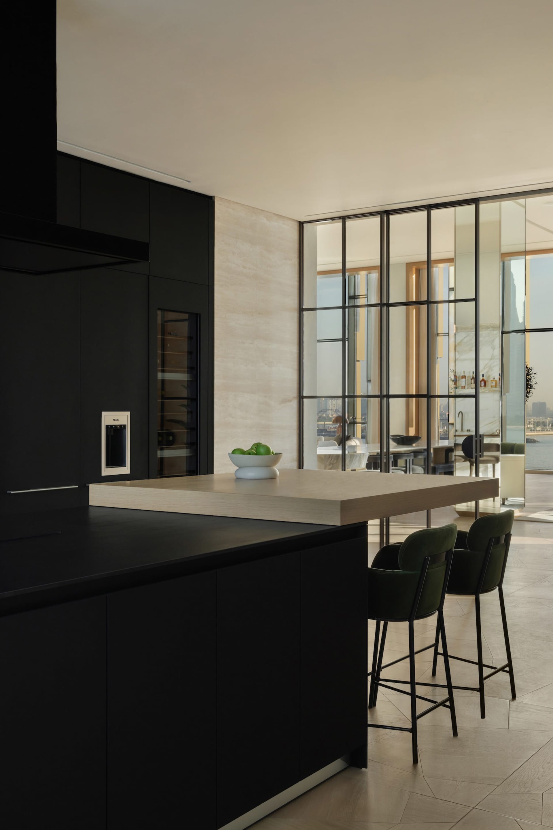 Modern kitchen featuring black cabinets and wood countertops.