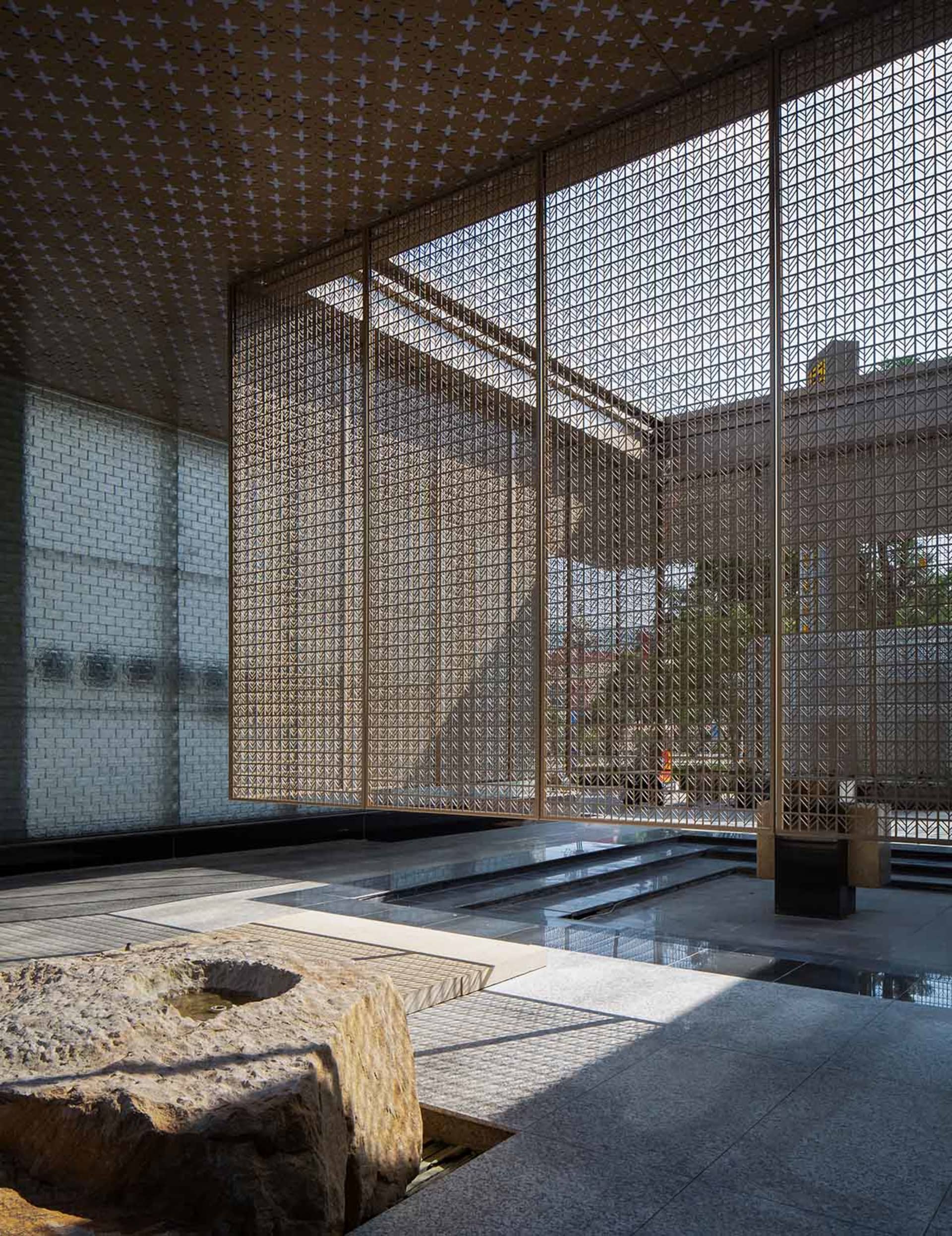 Modern interior design featuring glass walls, concrete flooring, and metal accents.