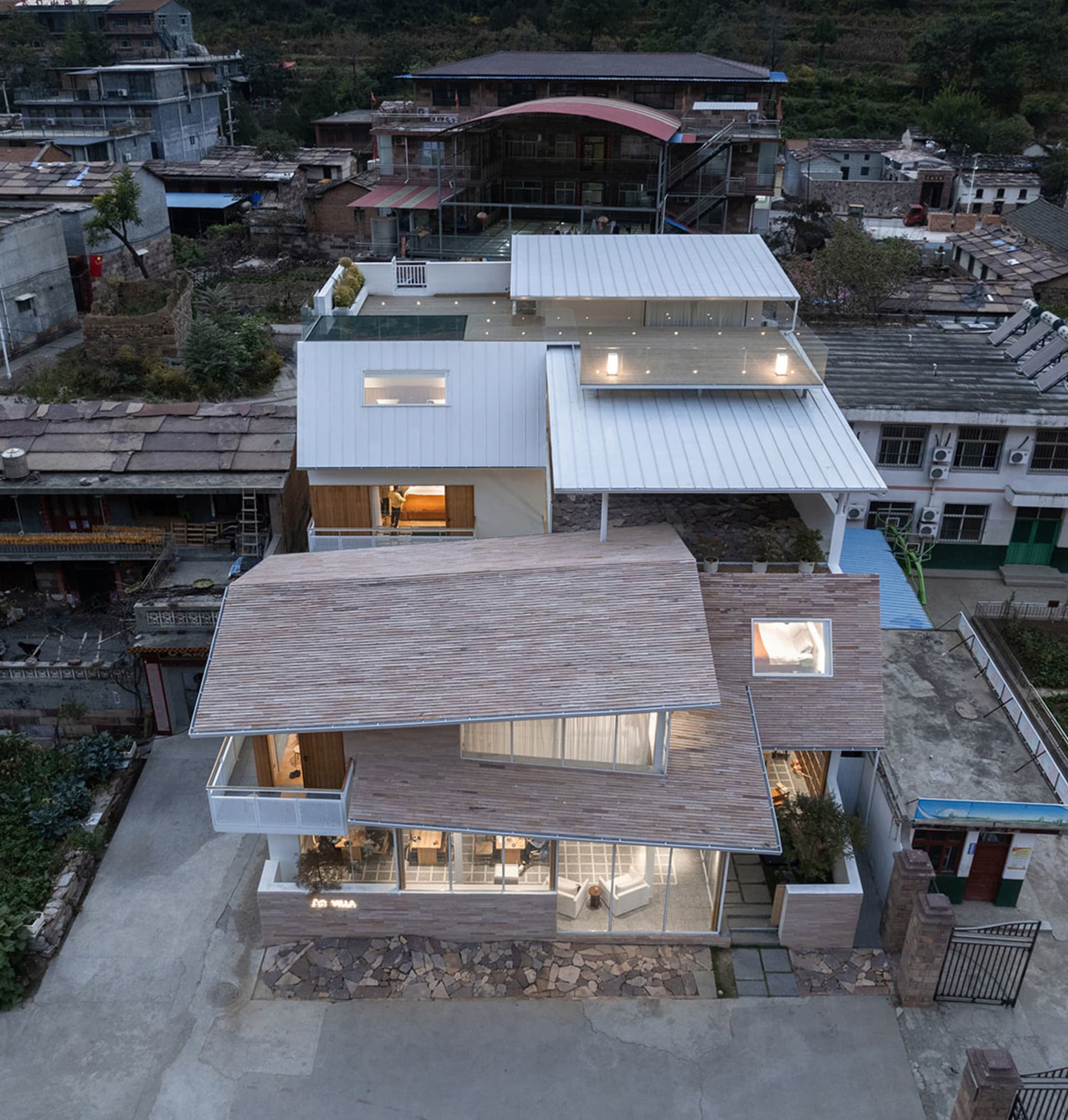 A modern minimalist villa with wood, glass, and metal materials.
