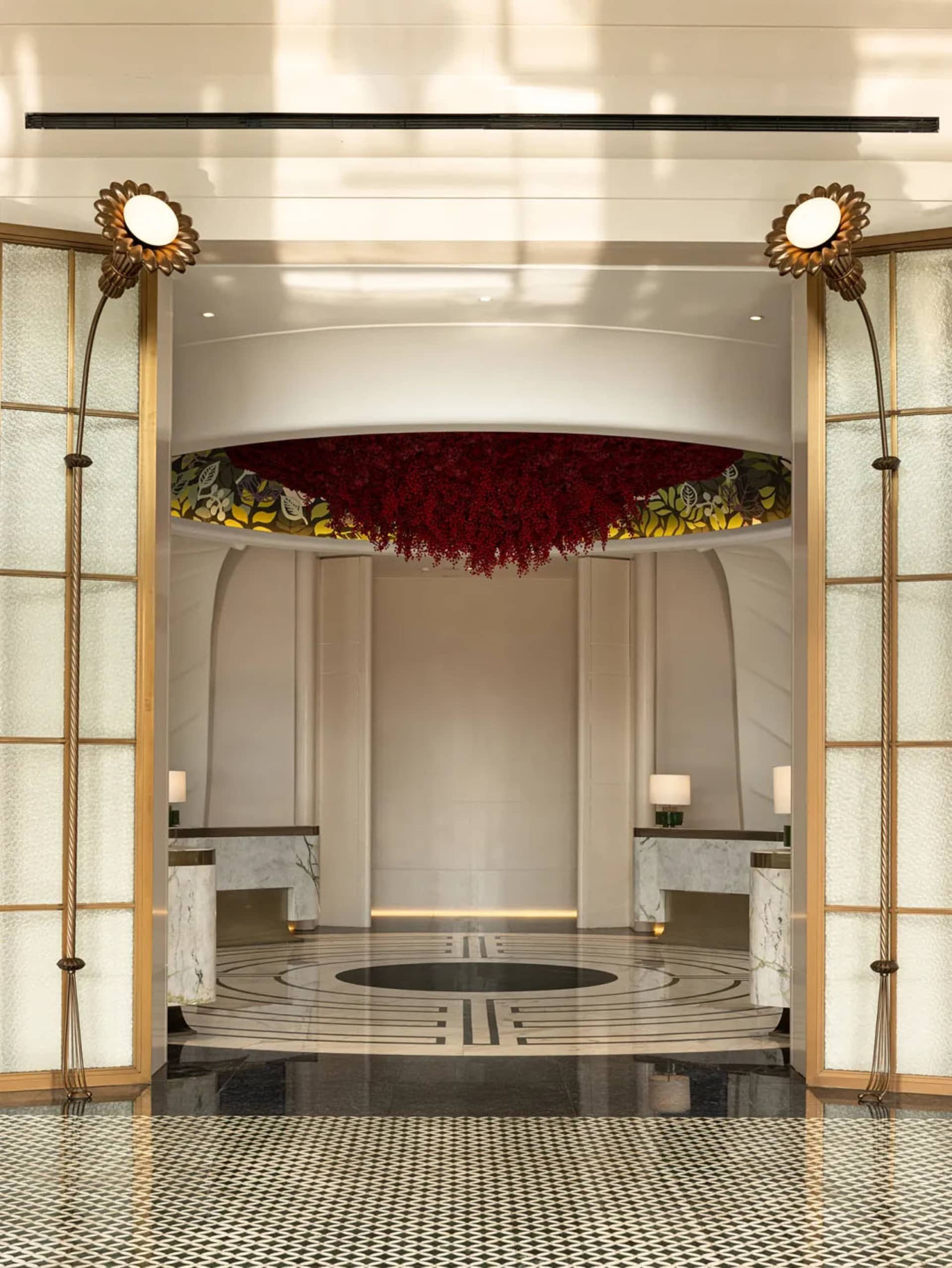 View of a modern hotel lobby featuring marble and concrete materials.