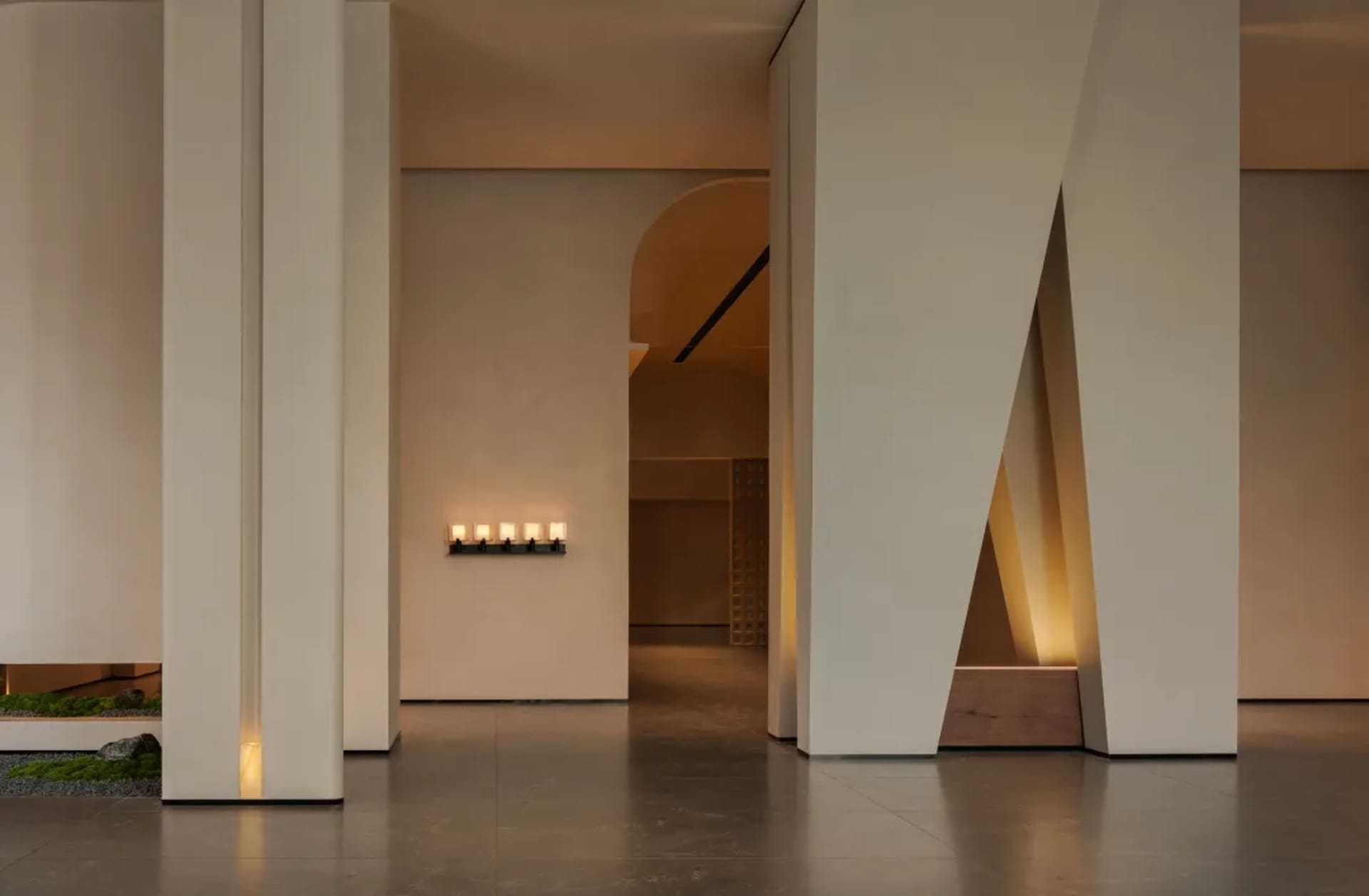 Modern interior space featuring concrete walls and wooden elements with minimalist lighting design.