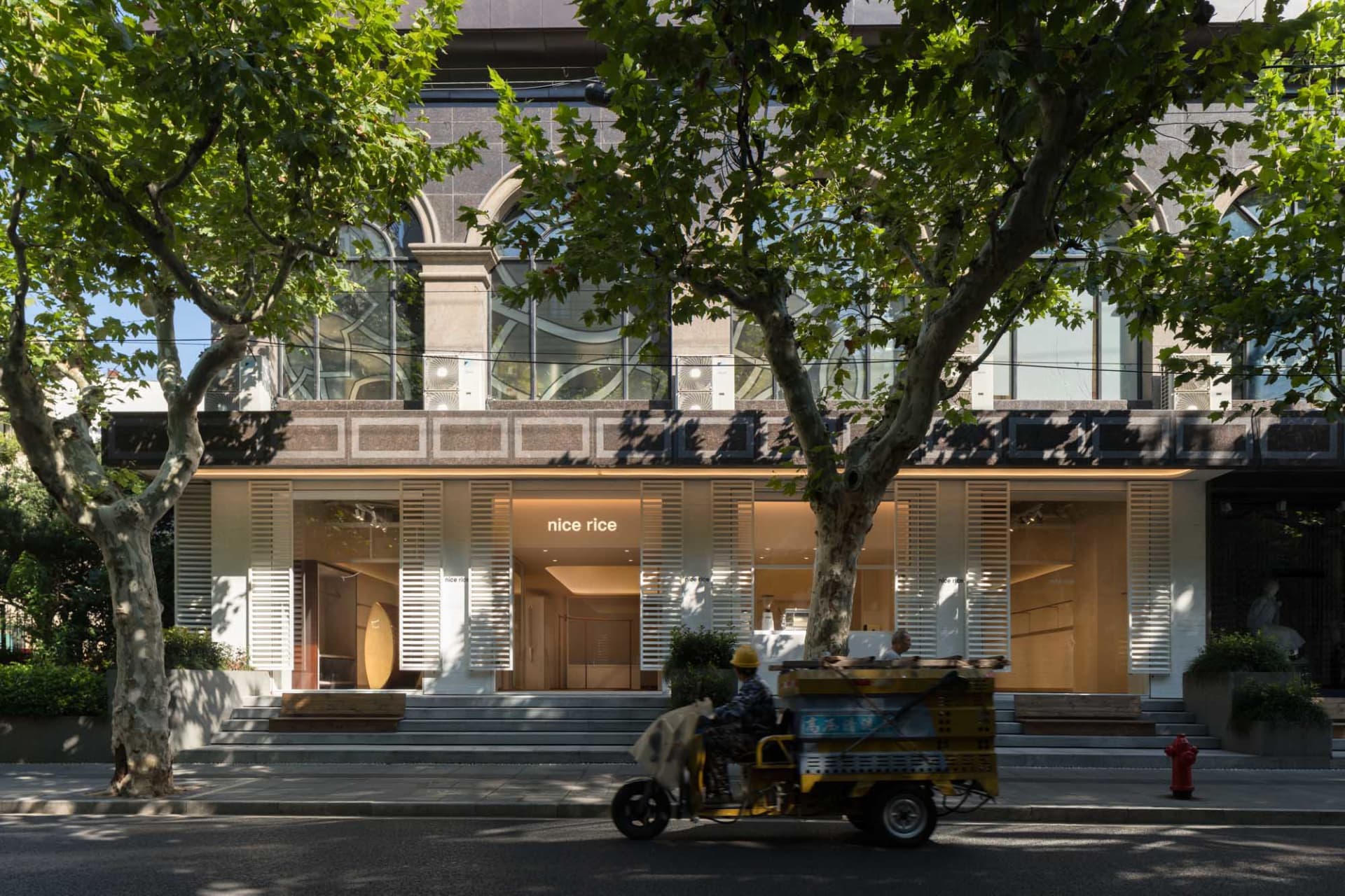 Modern storefront with large glass windows and stone facade