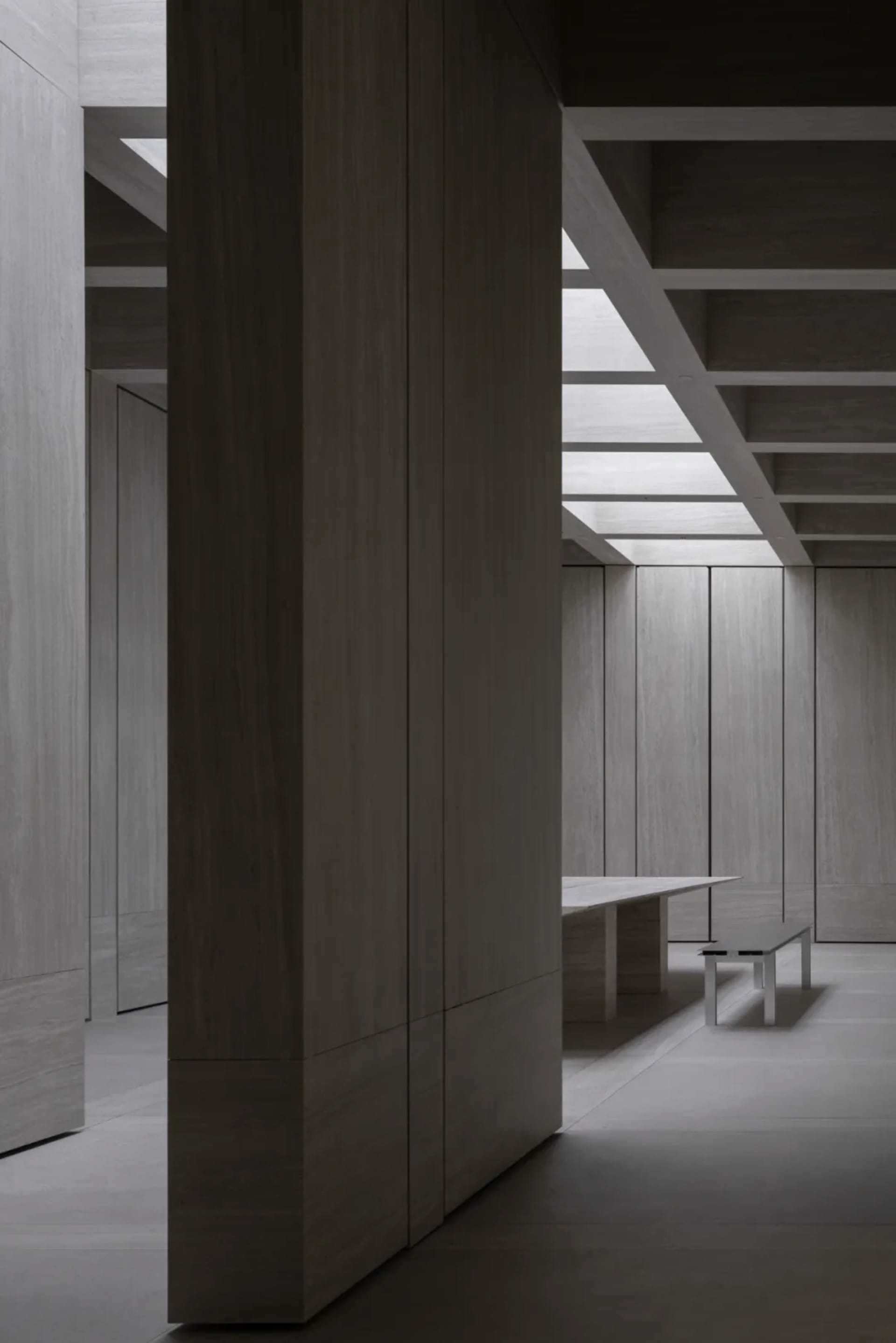 Modern office space featuring wooden panels on walls and ceiling.