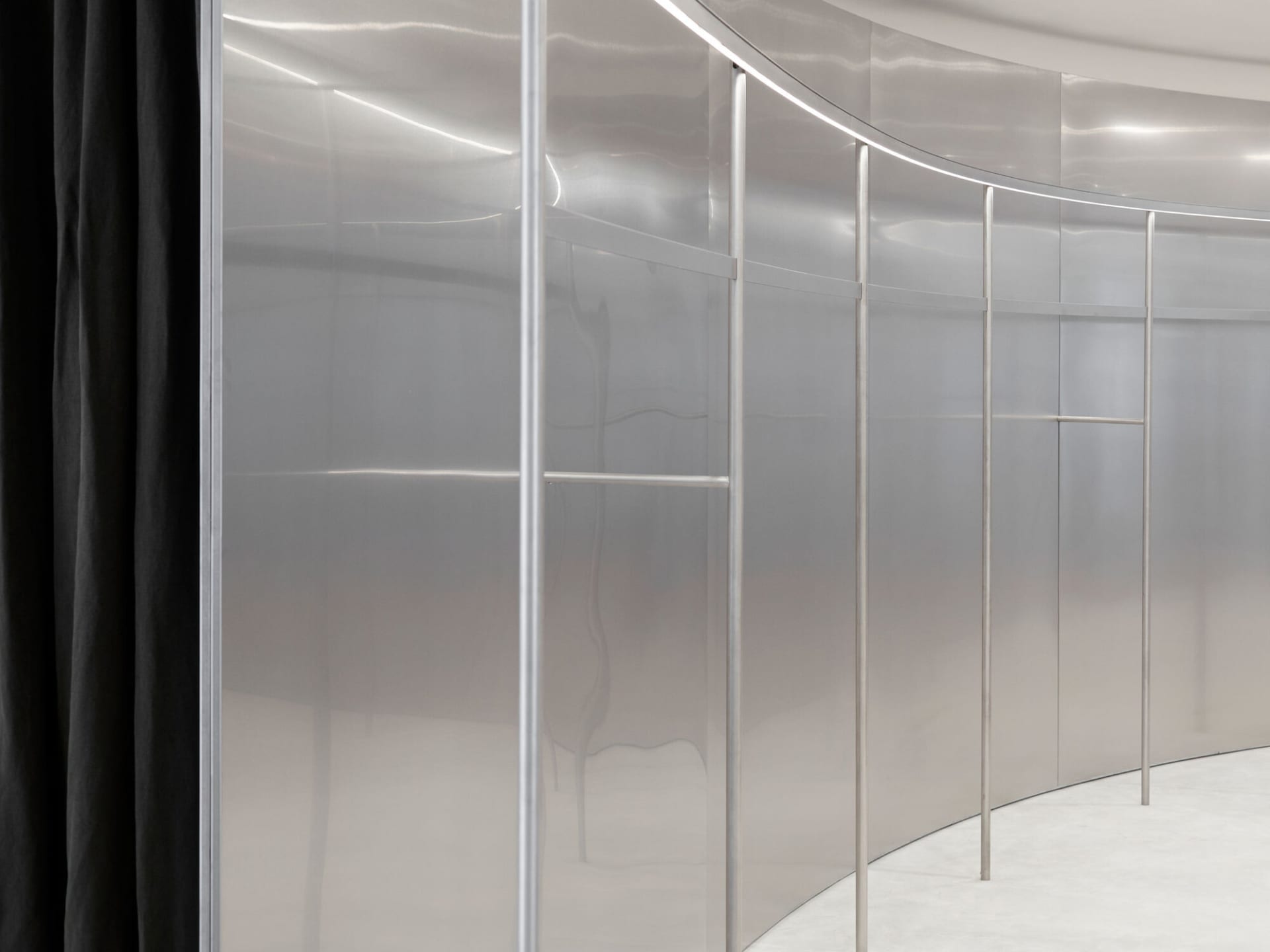 Modern interior design featuring a glass storefront display case with a sleek, minimalist aesthetic.