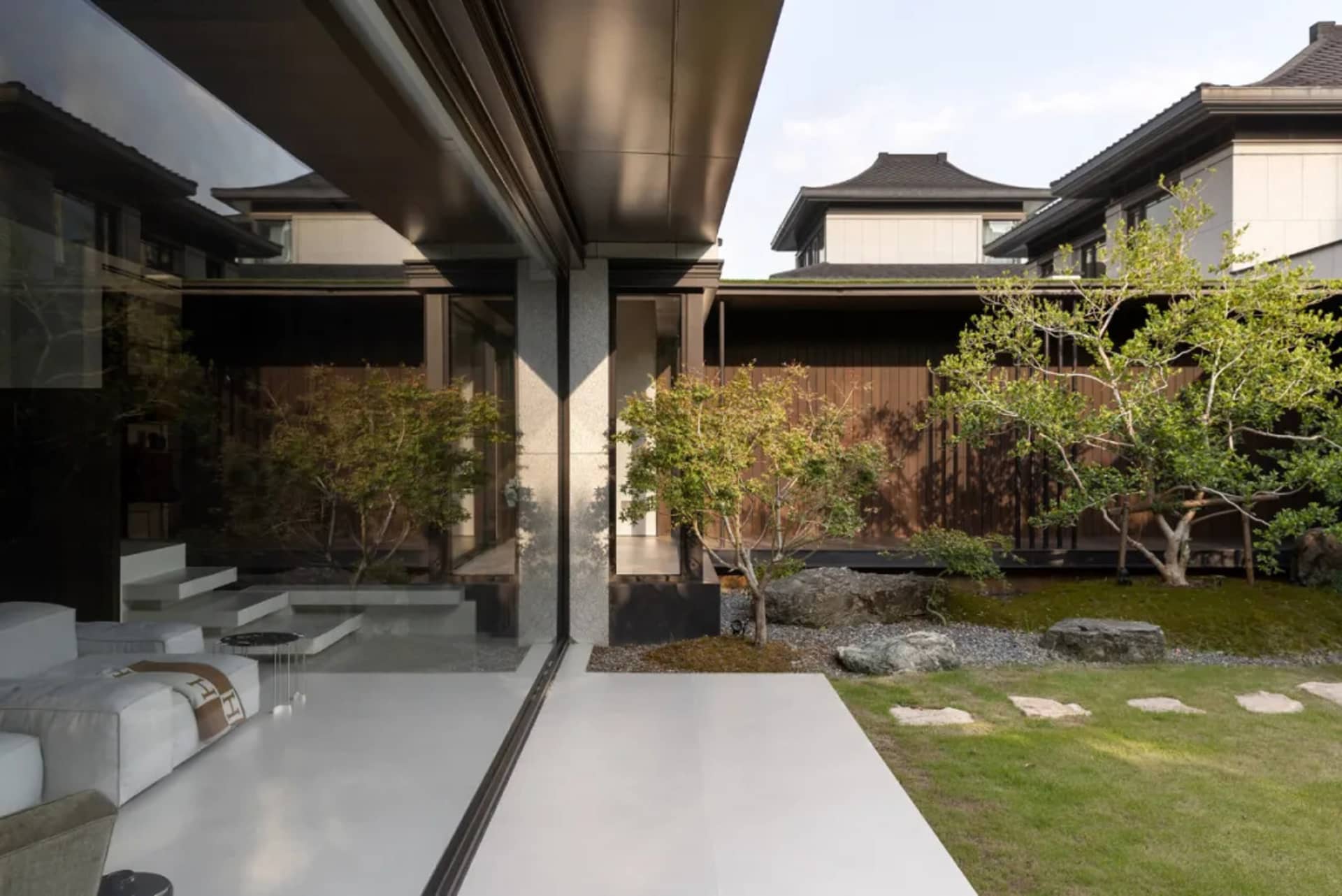 A modern residential exterior featuring a combination of glass and wood materials,with a minimalist design and an open floor 