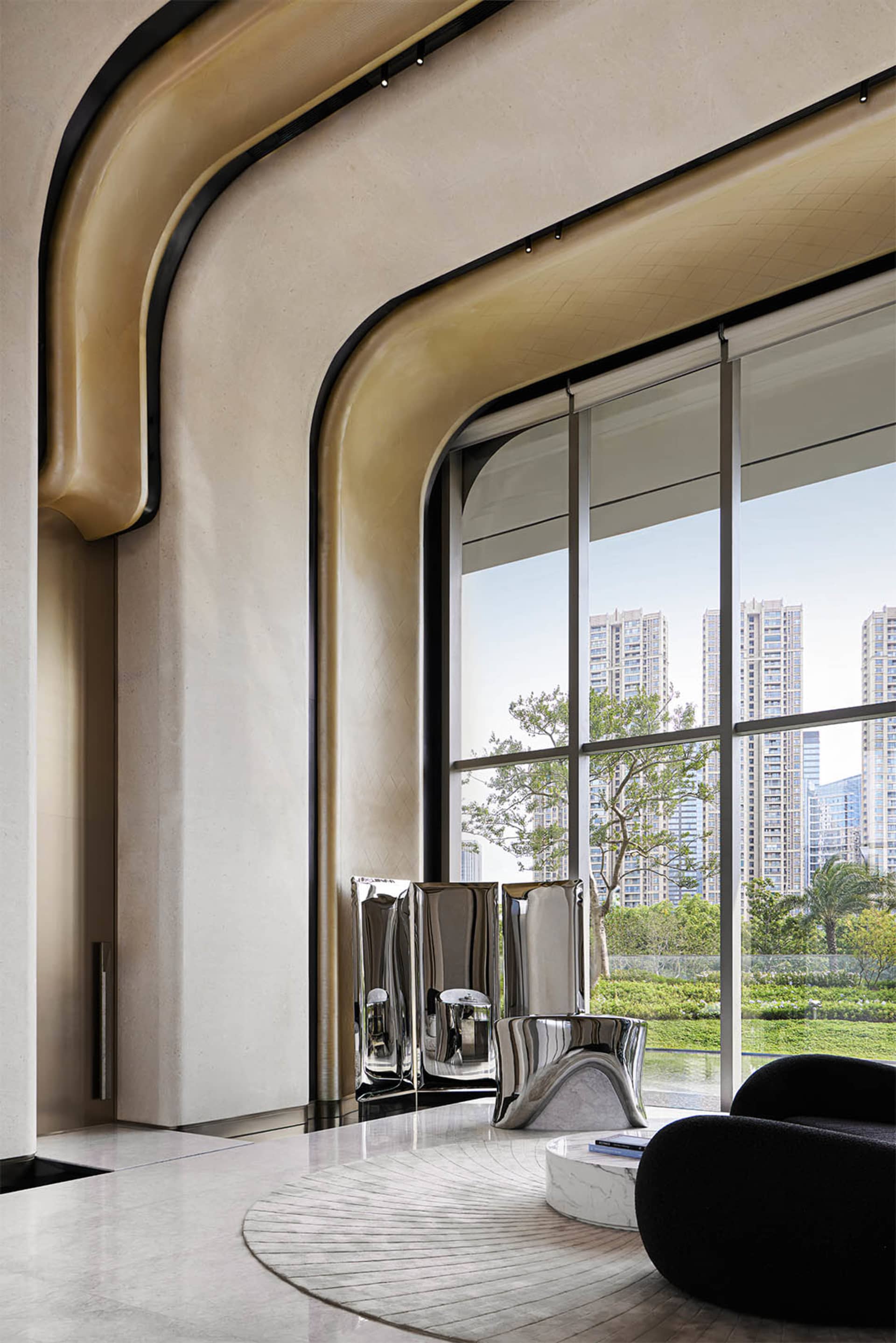 Modern living room featuring steel mirrors and marble furniture