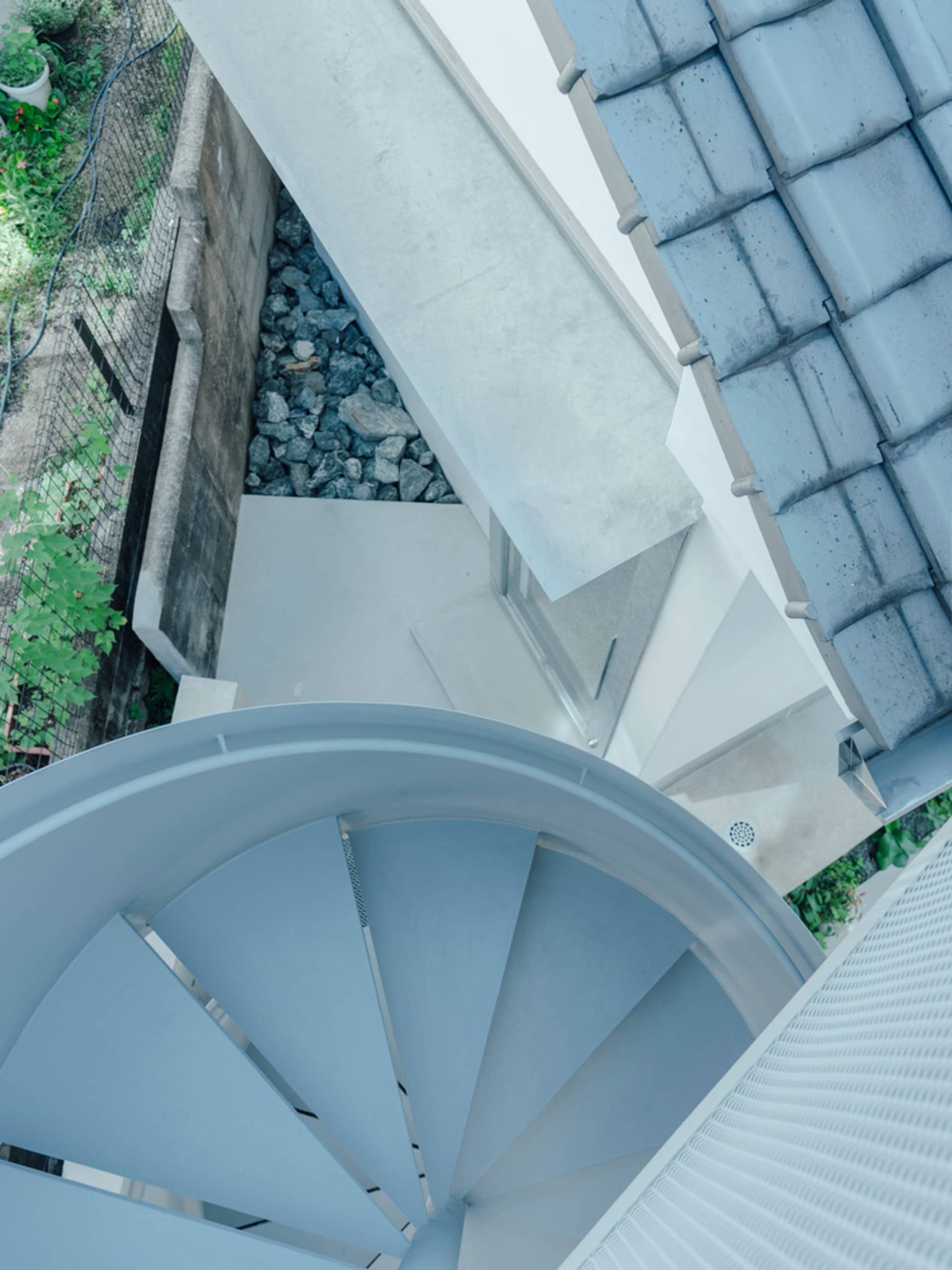 Modern metal stairs viewed from above, featuring smooth lines and a sleek design.