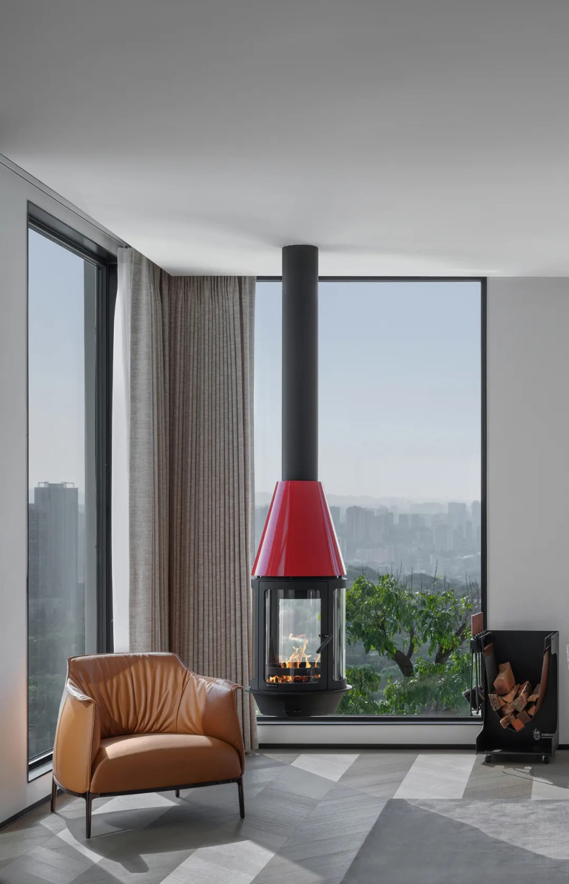 Modern living room featuring a glass ceiling with a red fireplace and a brown leather armchair.