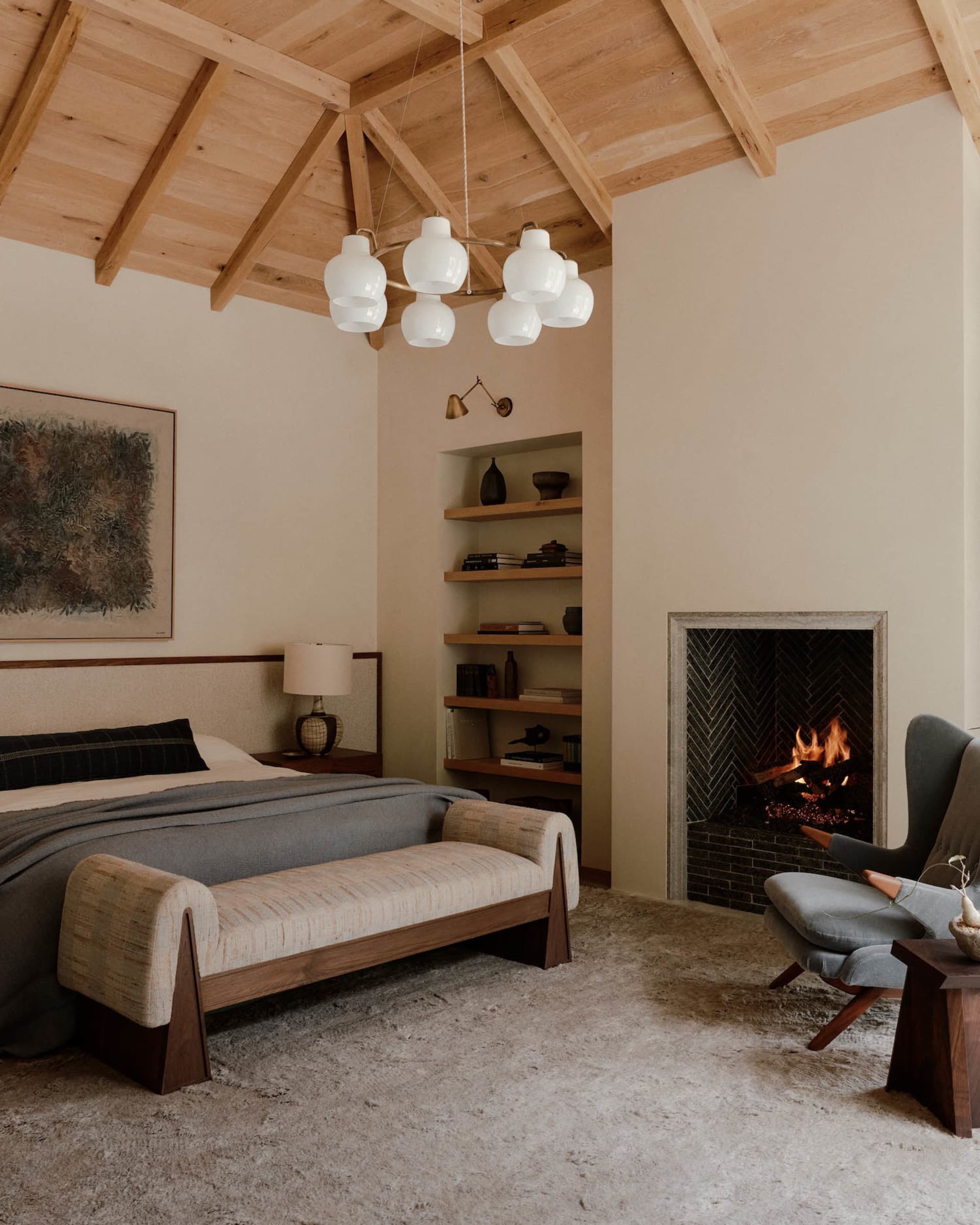 A minimalist bedroom with wood elements and a fireplace.