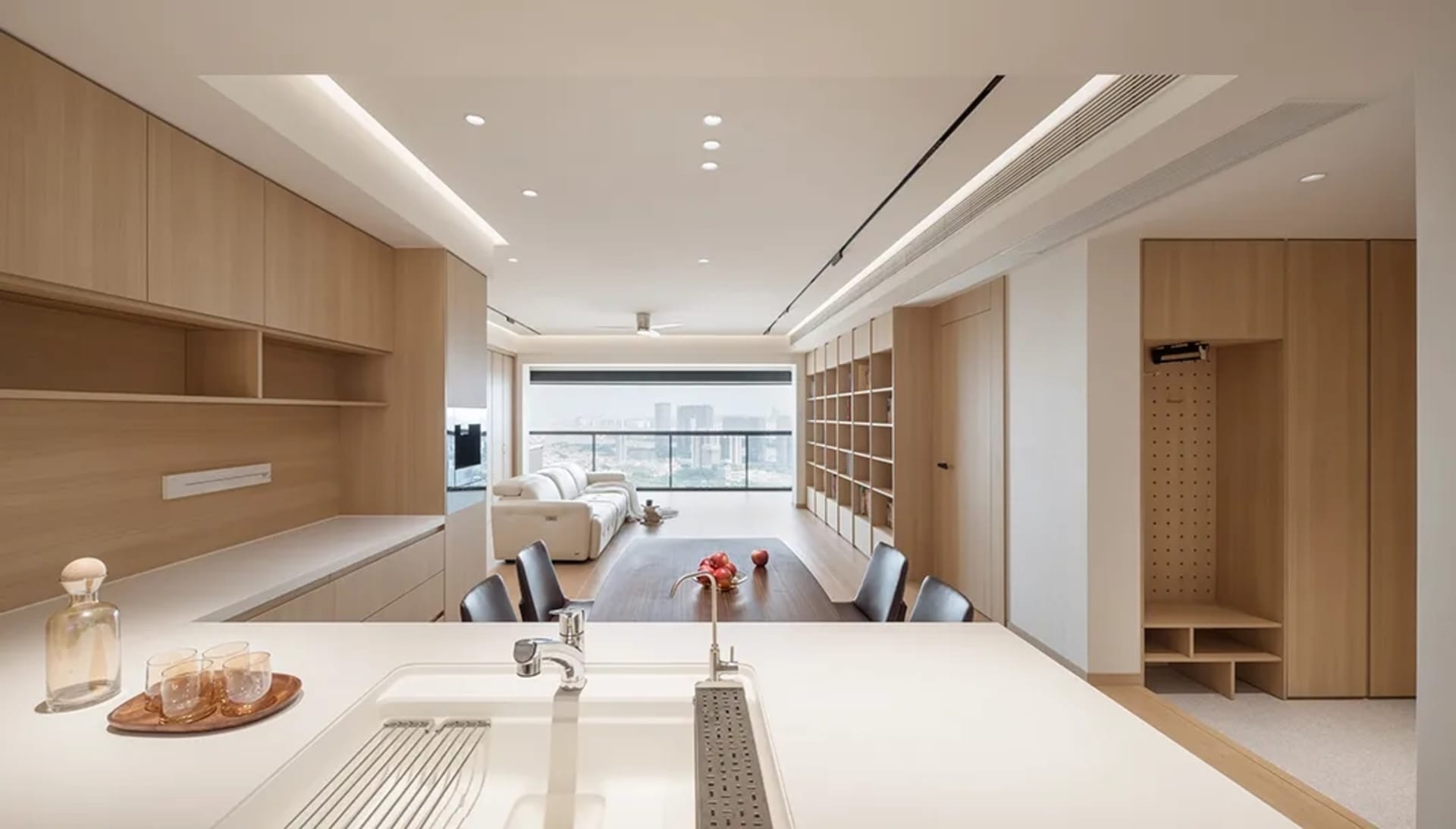 A minimalist residential kitchen featuring wooden cabinetry and countertops.