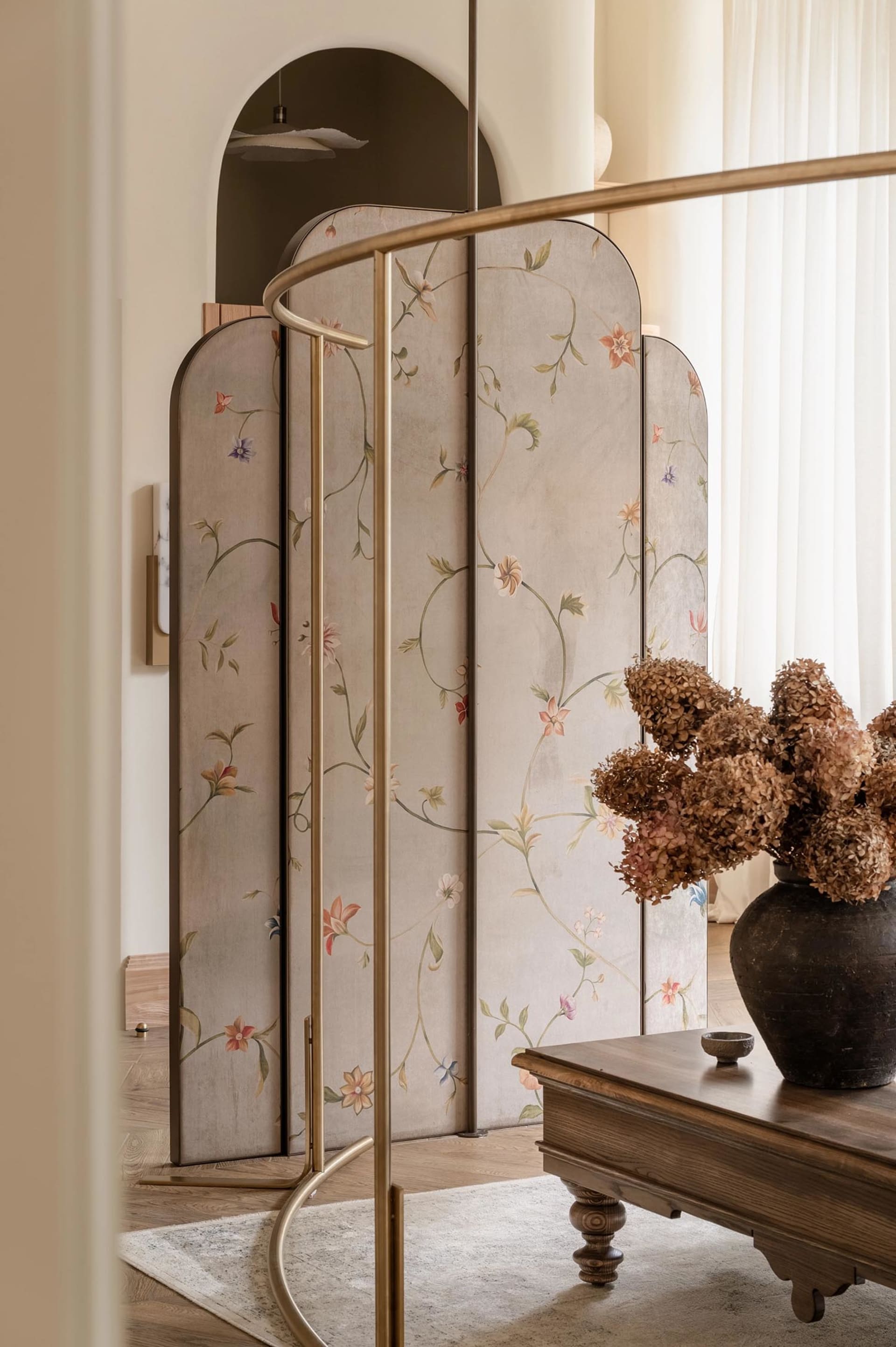 Modern, stylish divider screen with floral patterns in a living room setting.