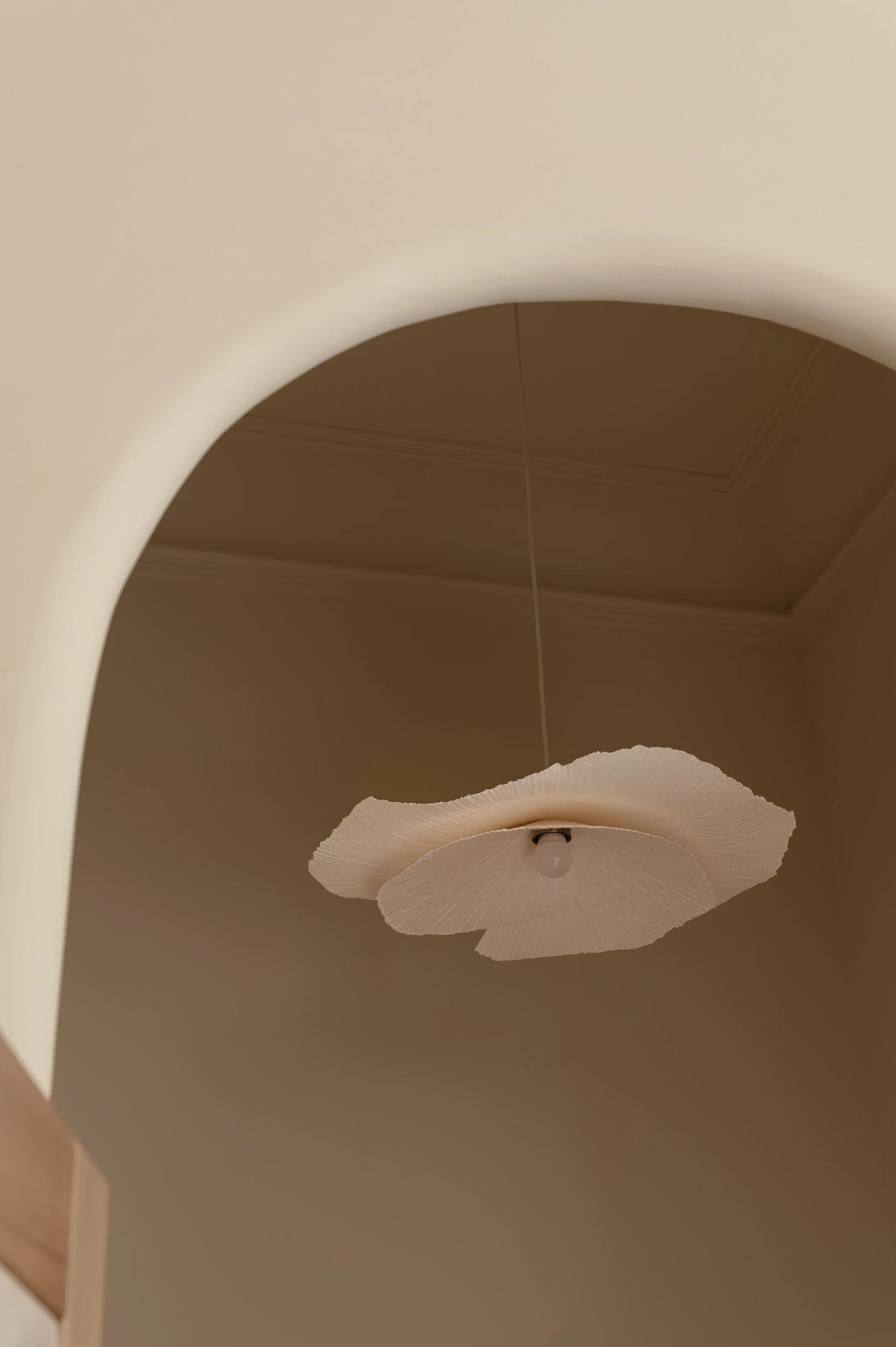 A modern ceiling lamp with textured paper shades hanging from a ceiling
