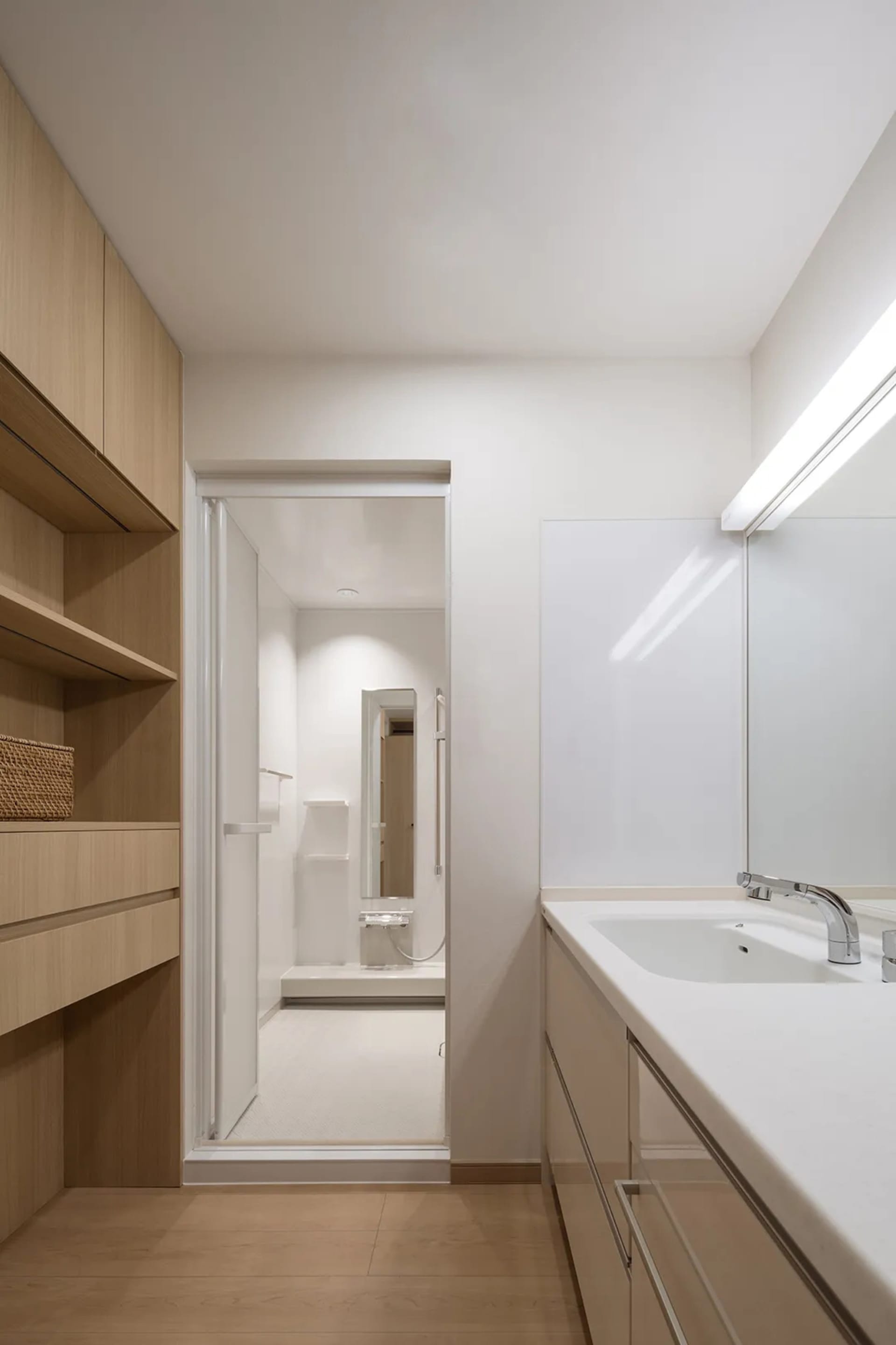 A minimalist bathroom featuring white porcelain fixtures and vanities.