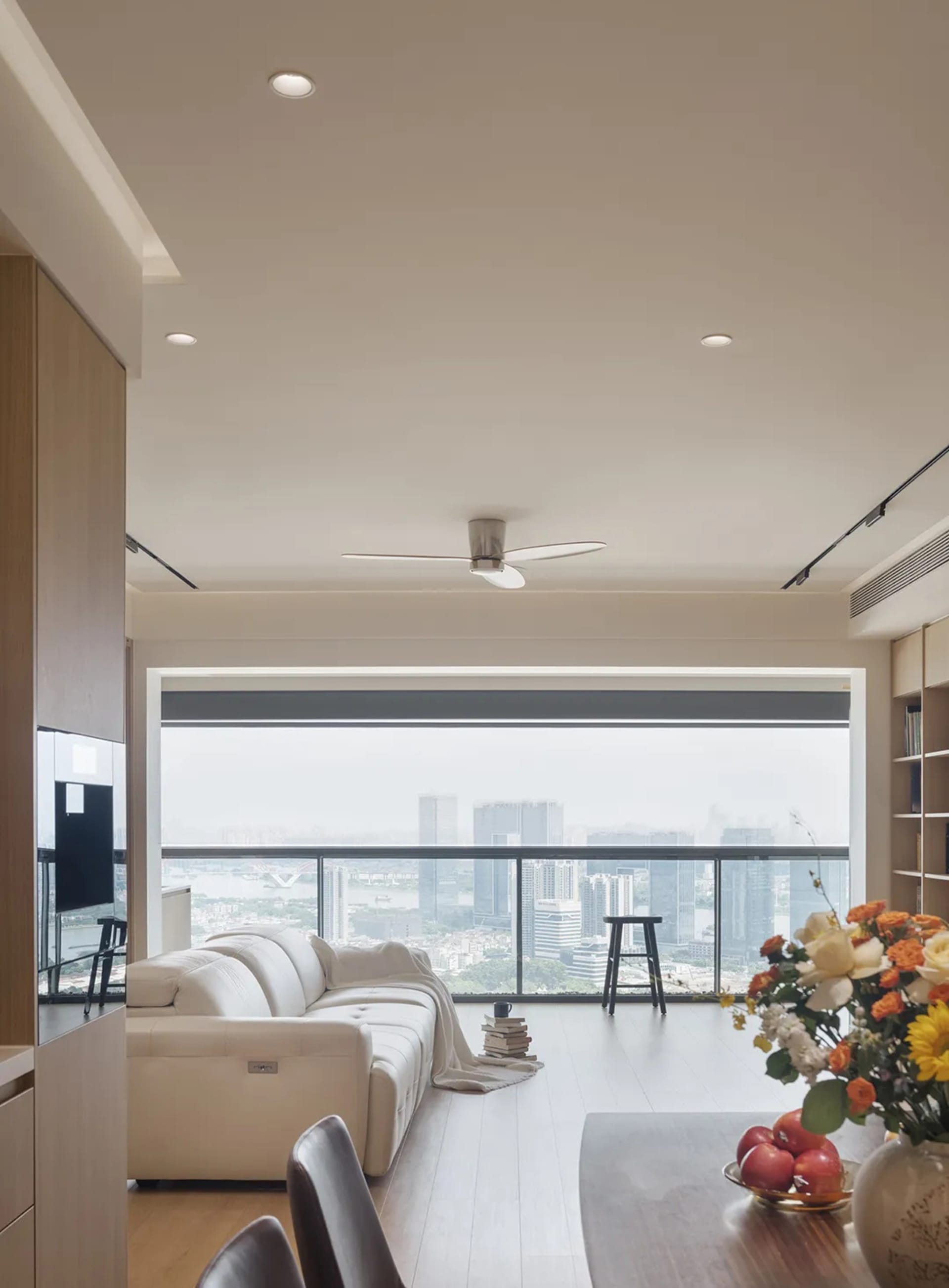 Modern interior design featuring a glass window and white leather sofa.