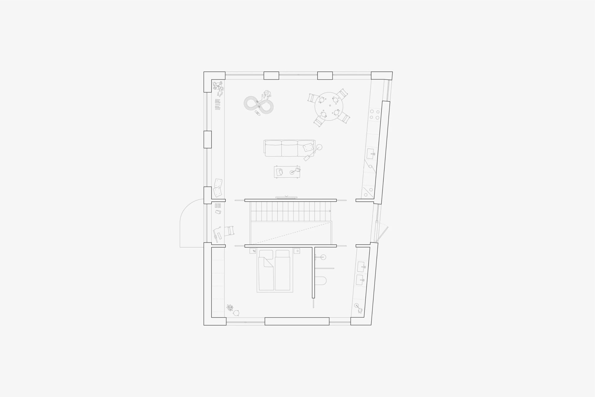 Floor plan of a residential apartment with living room, dining area, bedroom, and staircase.