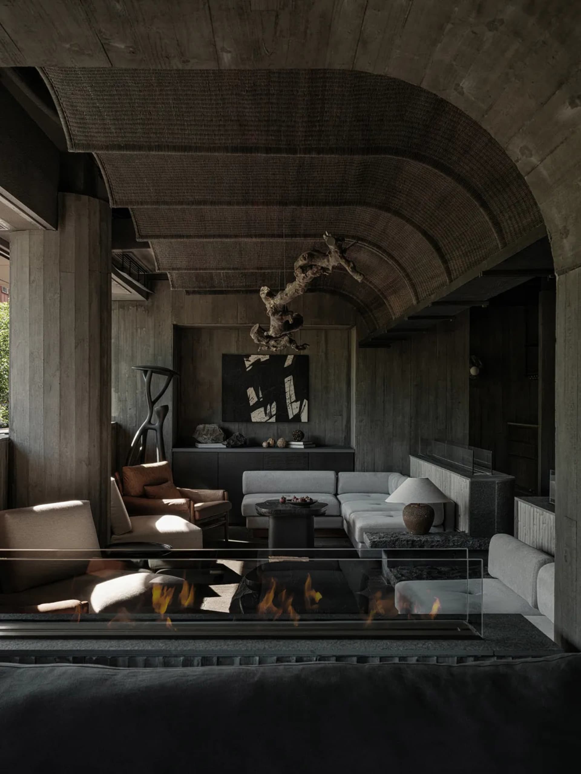 A living room with industrial design features, concrete materials, and minimalist furniture.