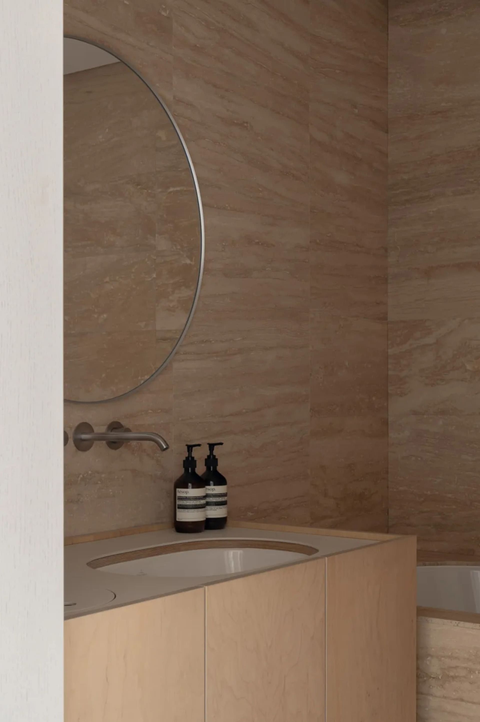 Modern bathroom featuring a sink with concrete walls and minimalist design.