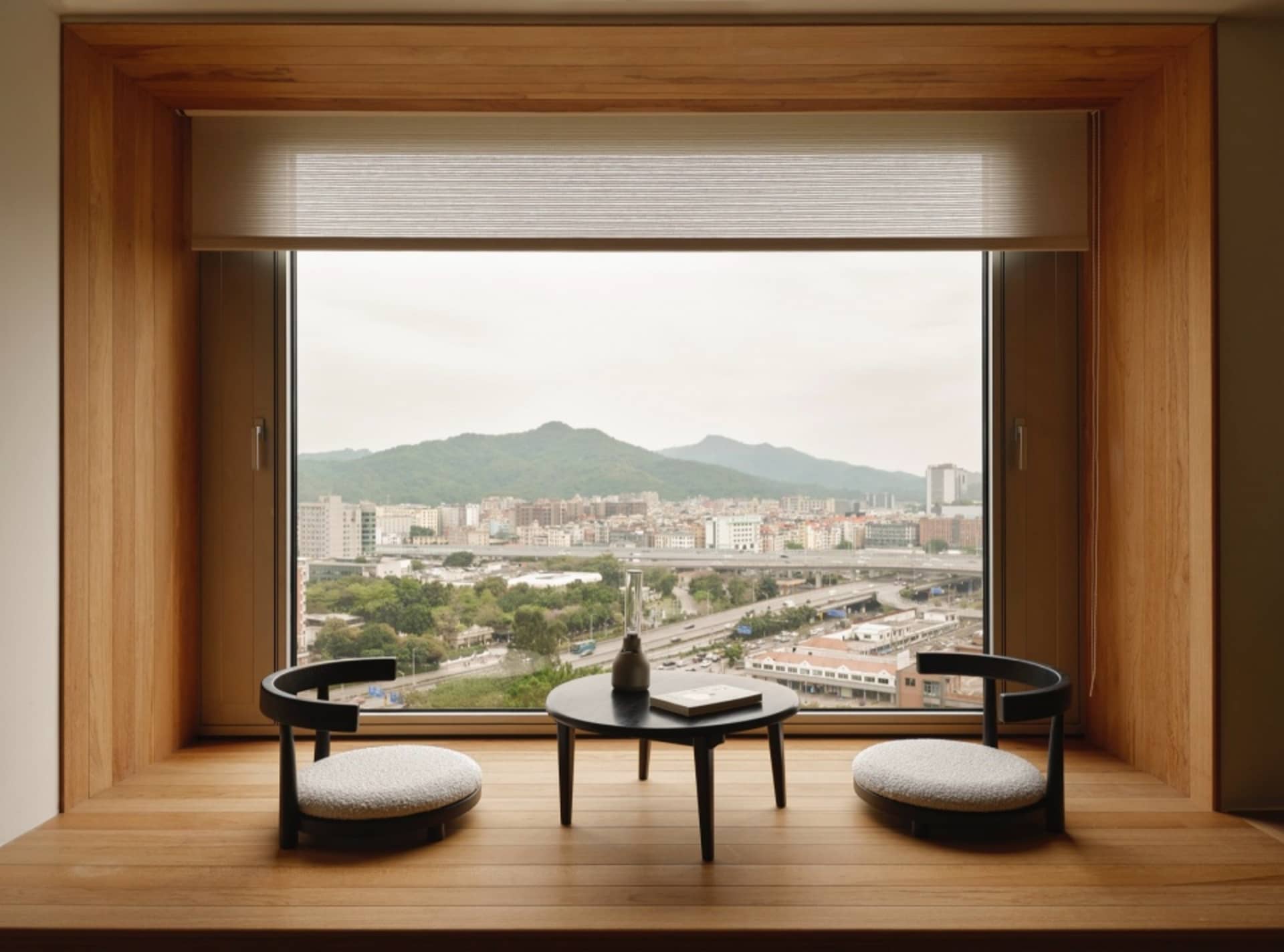 A cozy living room with a modern window overlooking a cityscape.