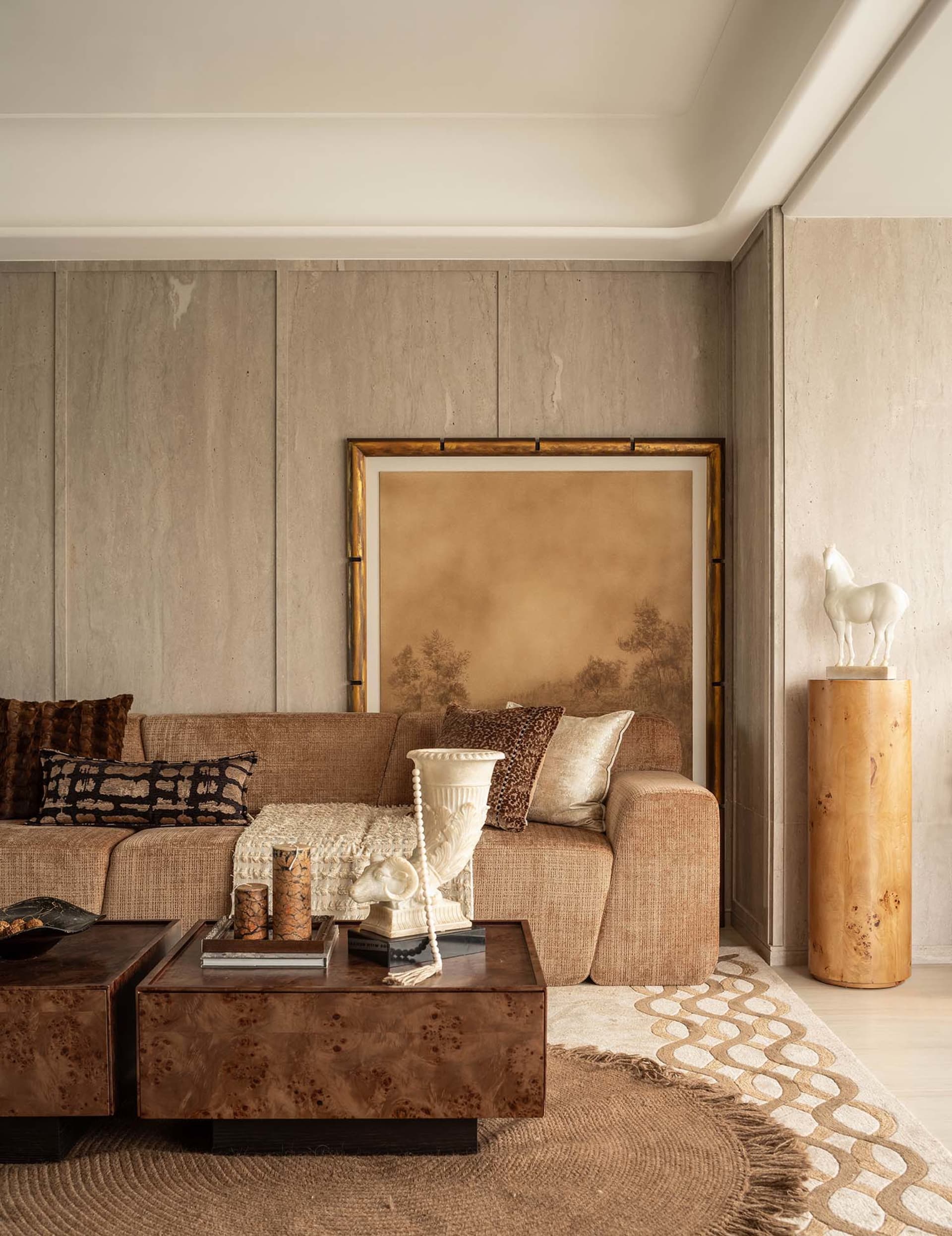 A modern living room with wooden furniture, including a sofa, coffee tables, and decorative items.