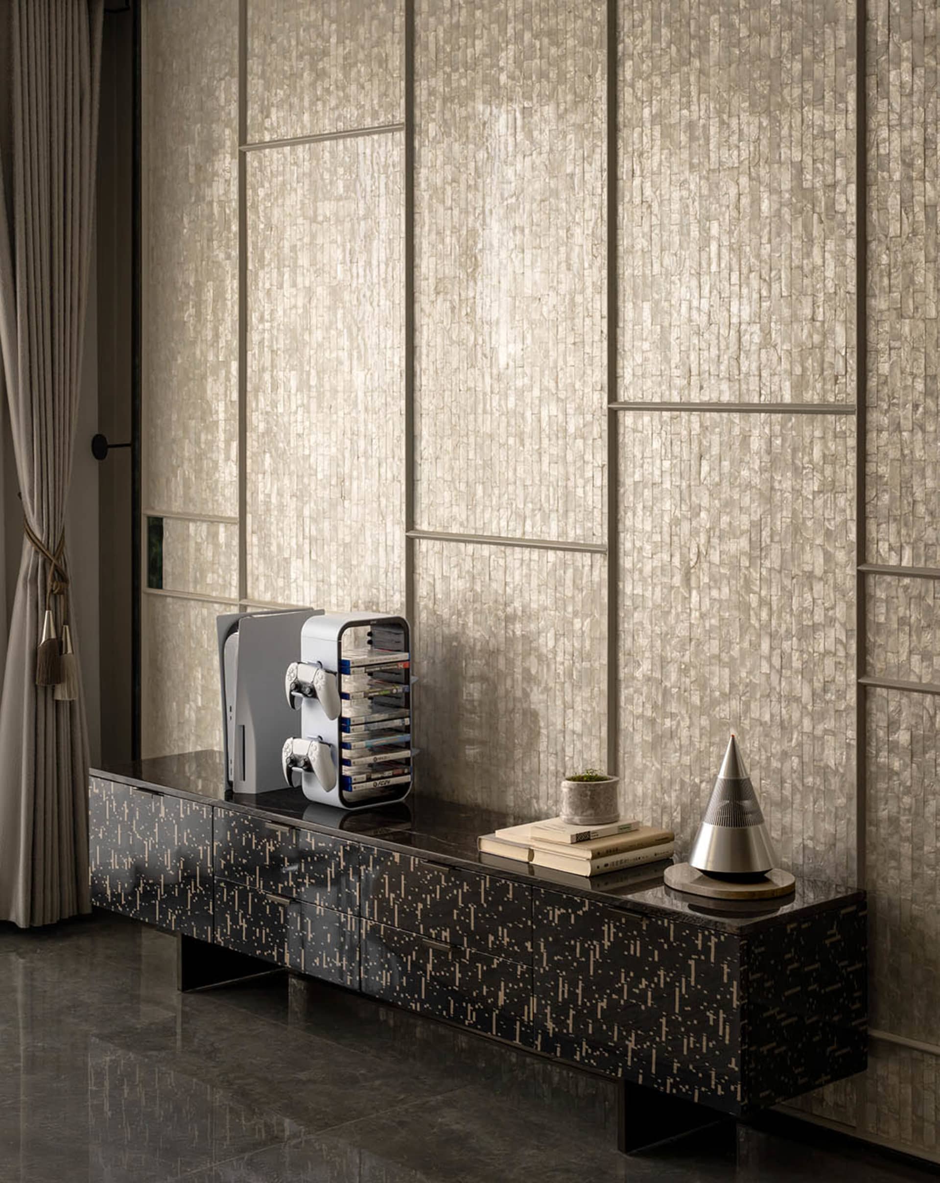 A modern living room with black steel accents and metallic finishes.