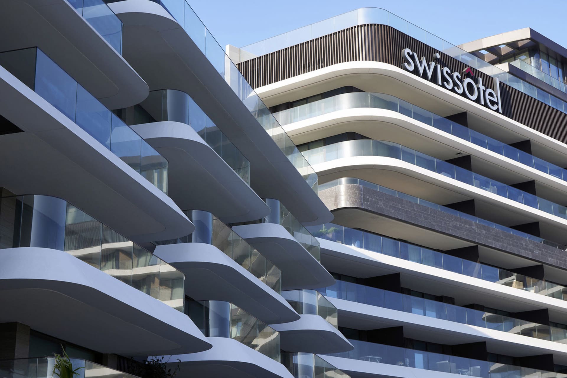 Swissotel hotel with modern glass and concrete design features.