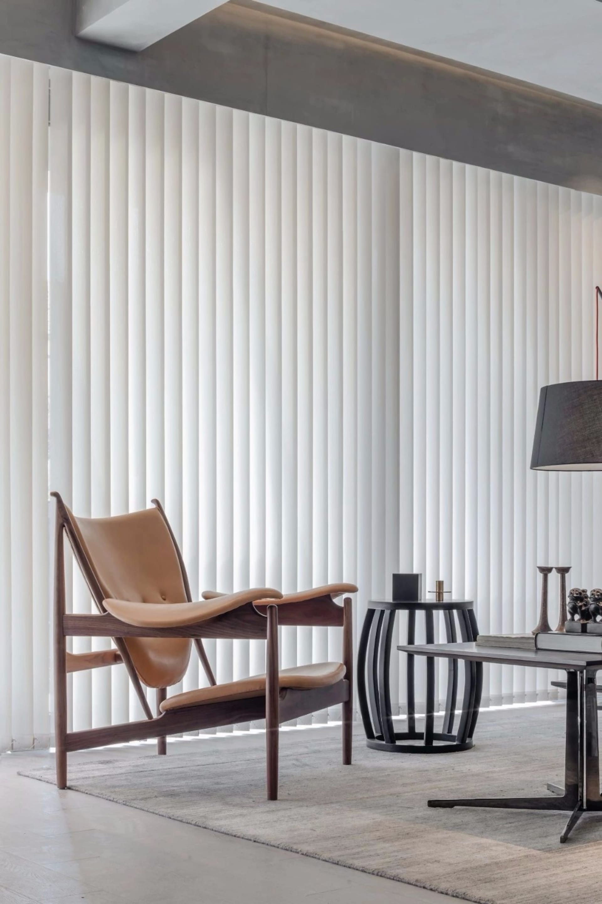 Modern living room with leather furniture, wooden accents, and metallic elements