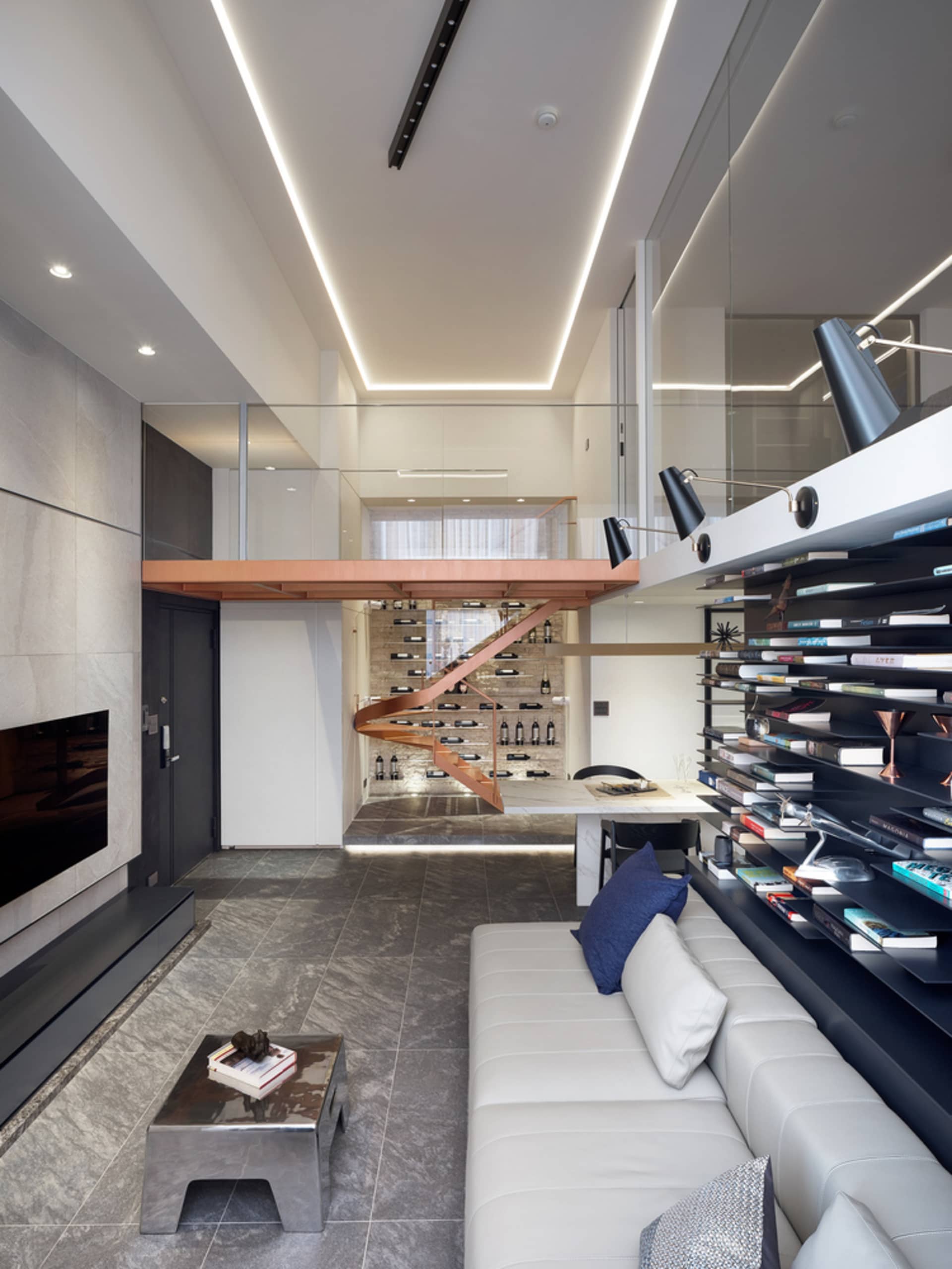 Modern living room with a metal coffee table, concrete floor, and wooden accents.