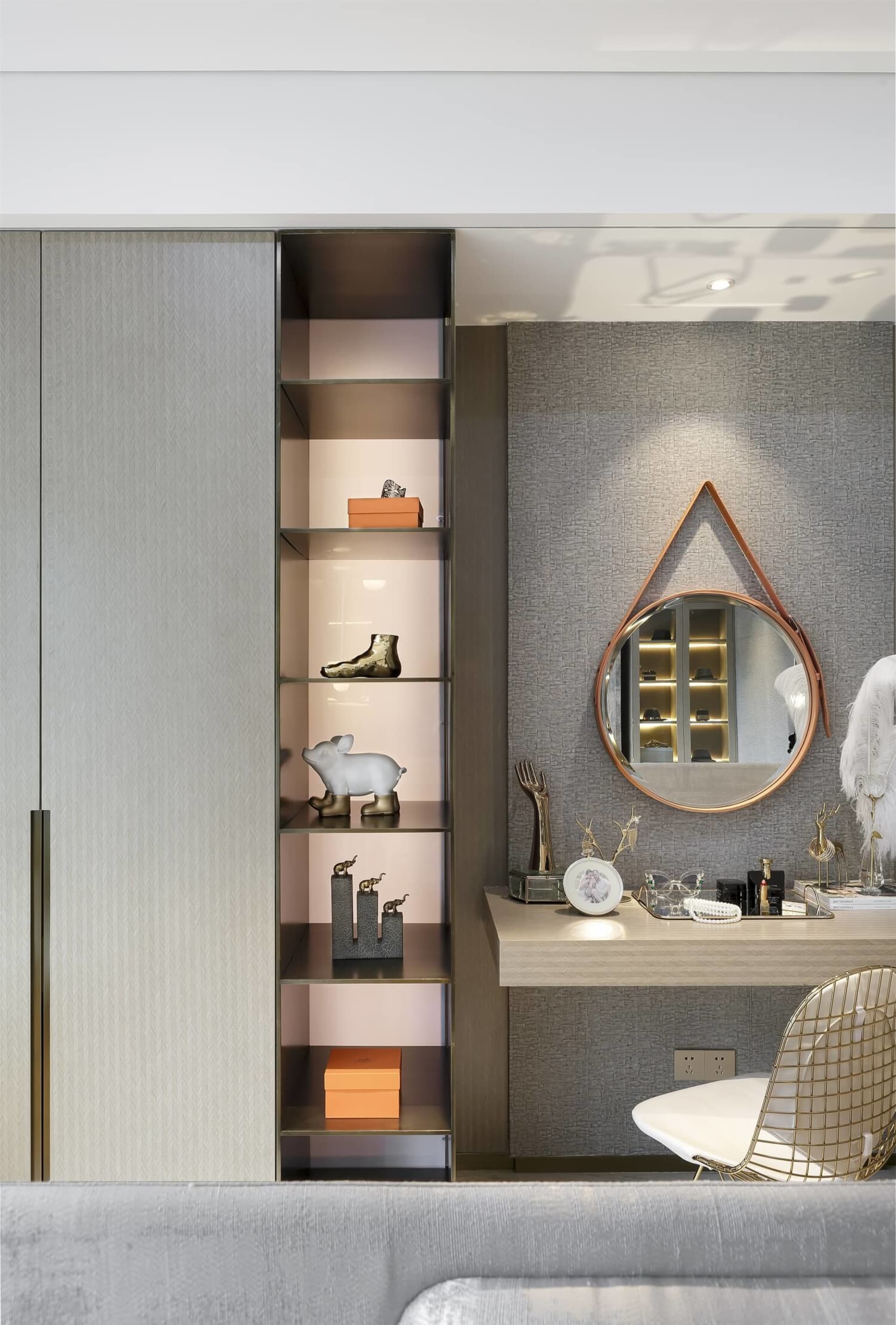Modern dresser space featuring metallic shelves and a circular mirror.
