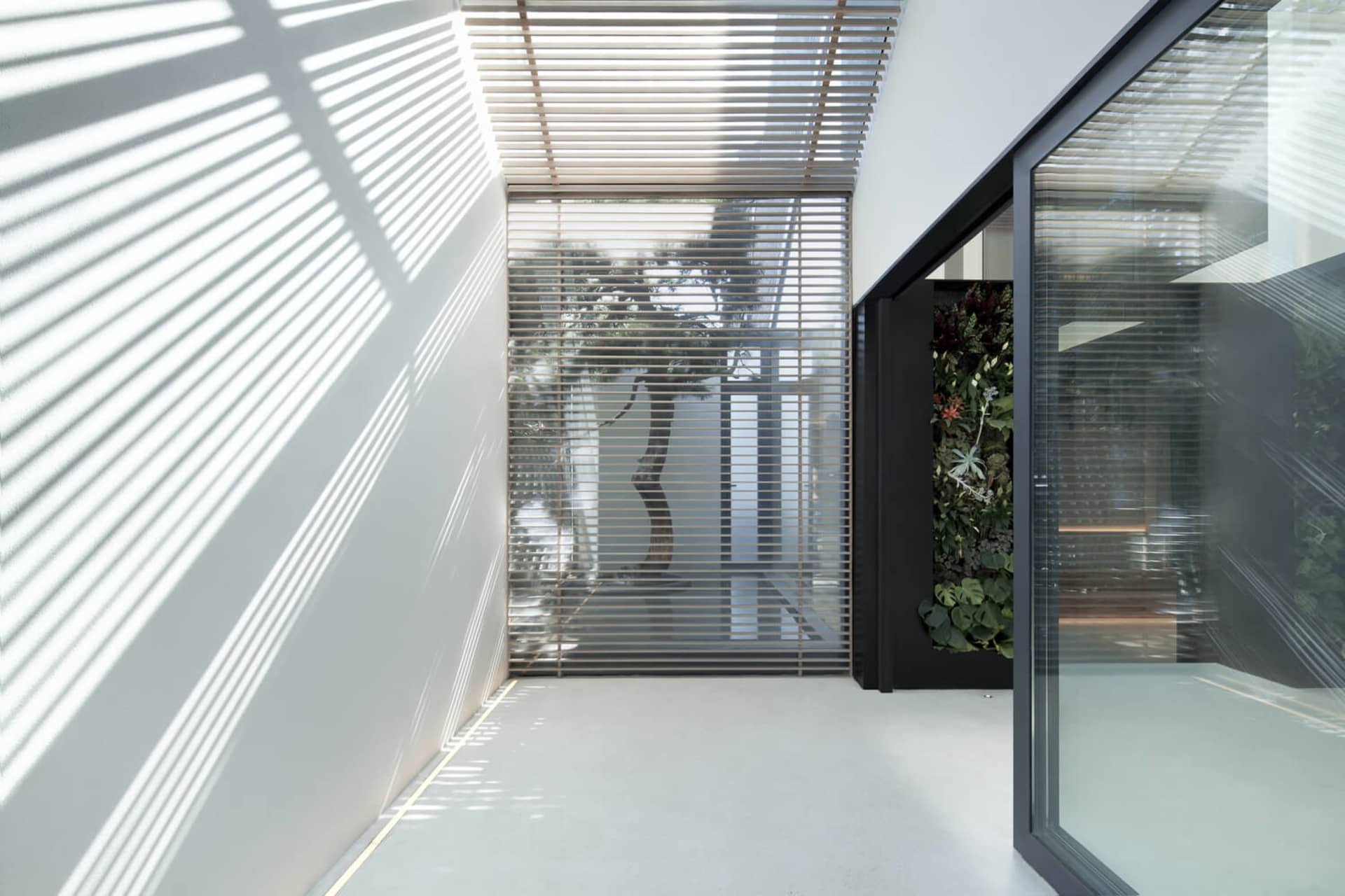 Modern industrial interior design featuring metal, glass, and concrete materials.