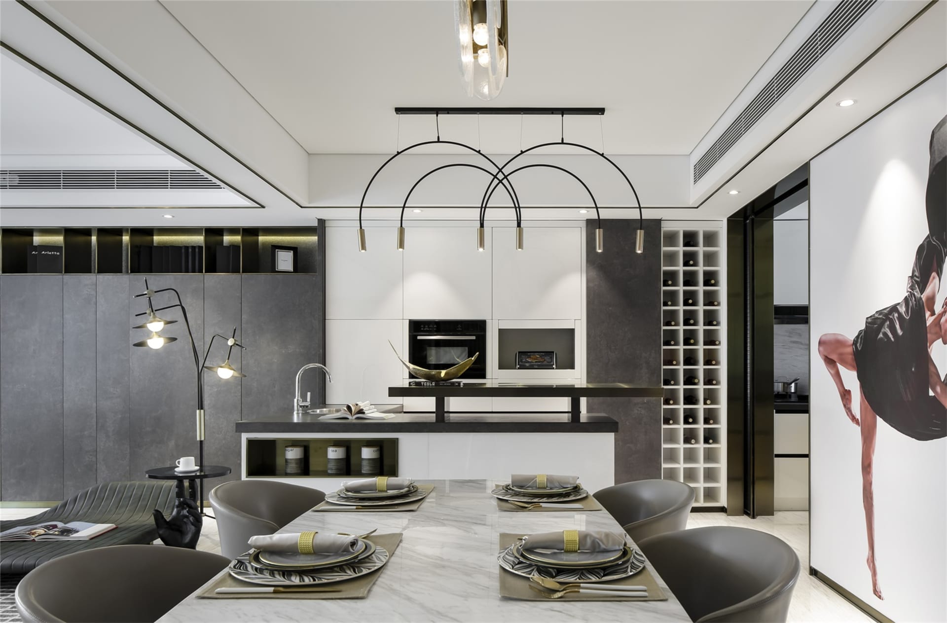 Modern kitchen with marble countertops, glass cabinets, and a white center island.