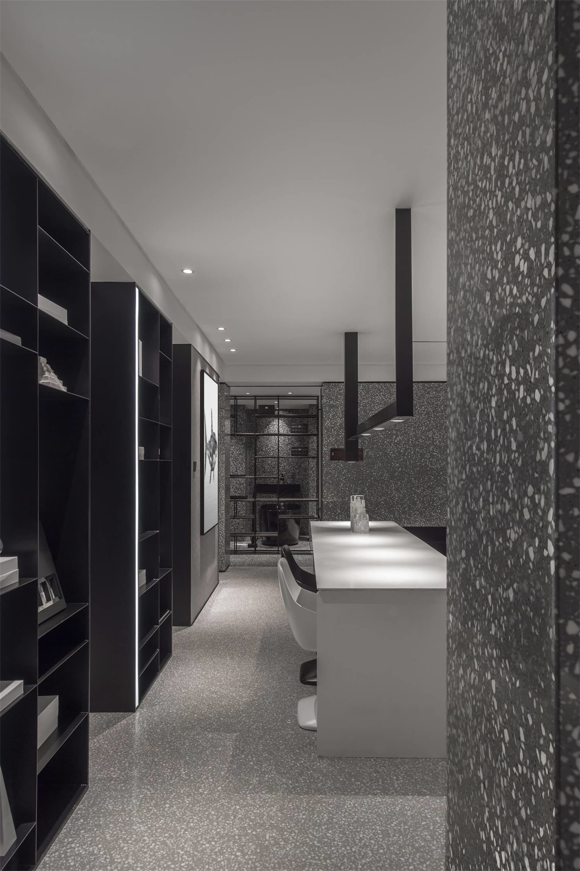 A modern office space featuring a unique terrazzo floor, designed with sleek lines and a minimalist aesthetic.