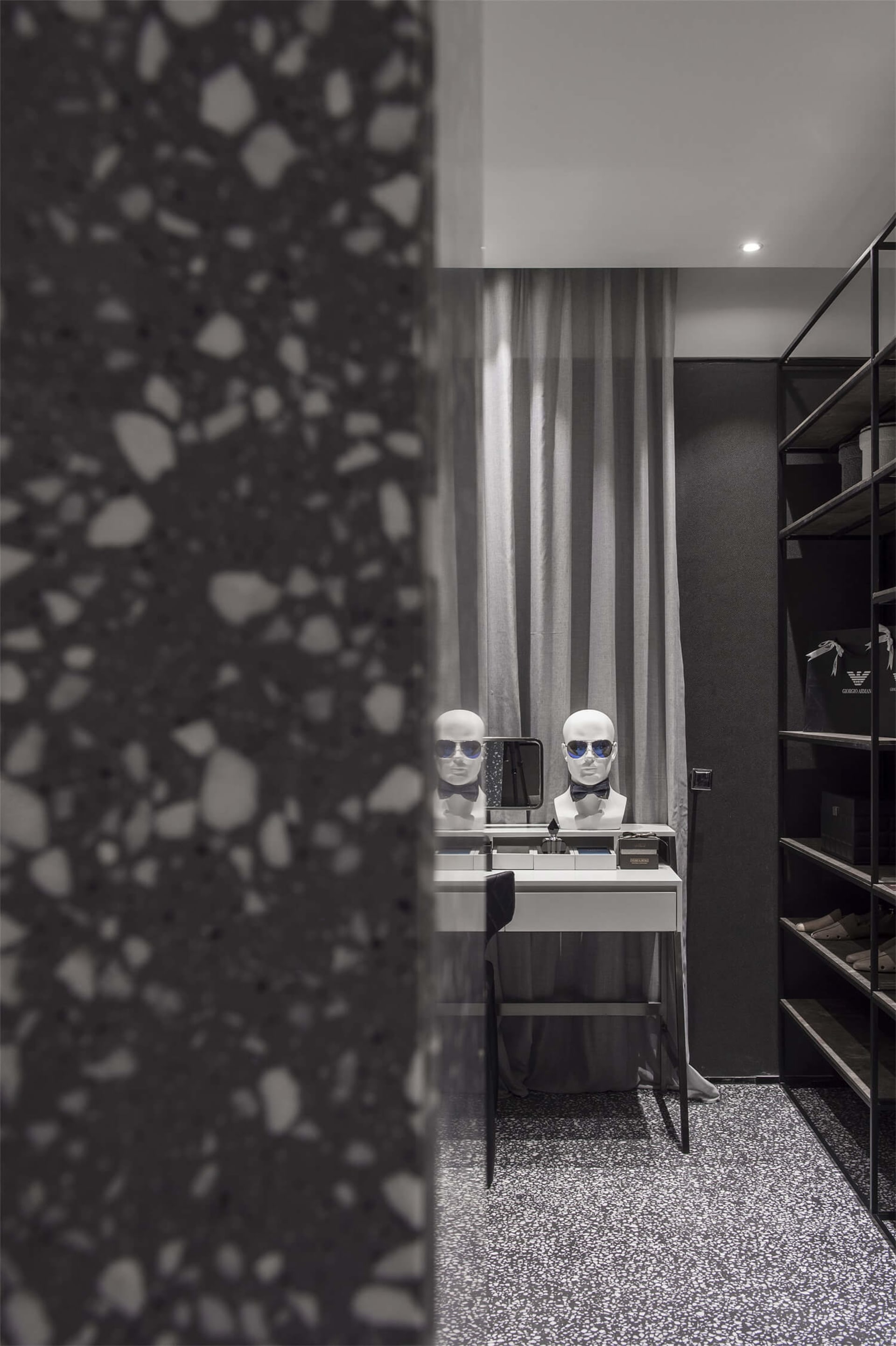 A modern wardrobe featuring a terrazzo floor and minimalist design.