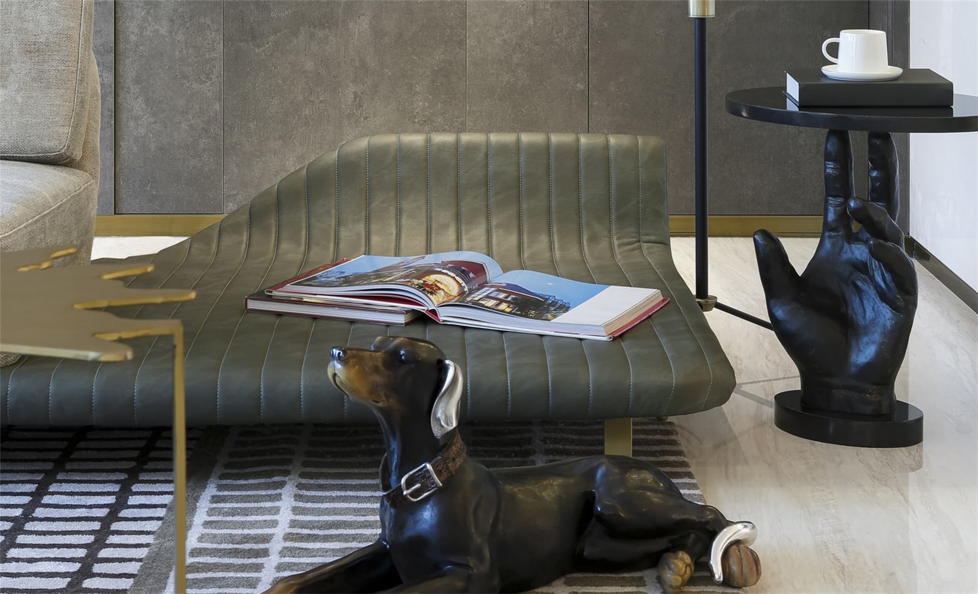 Modern living room featuring a green leather sofa with an open coffee table displaying a book and a small black side table wi