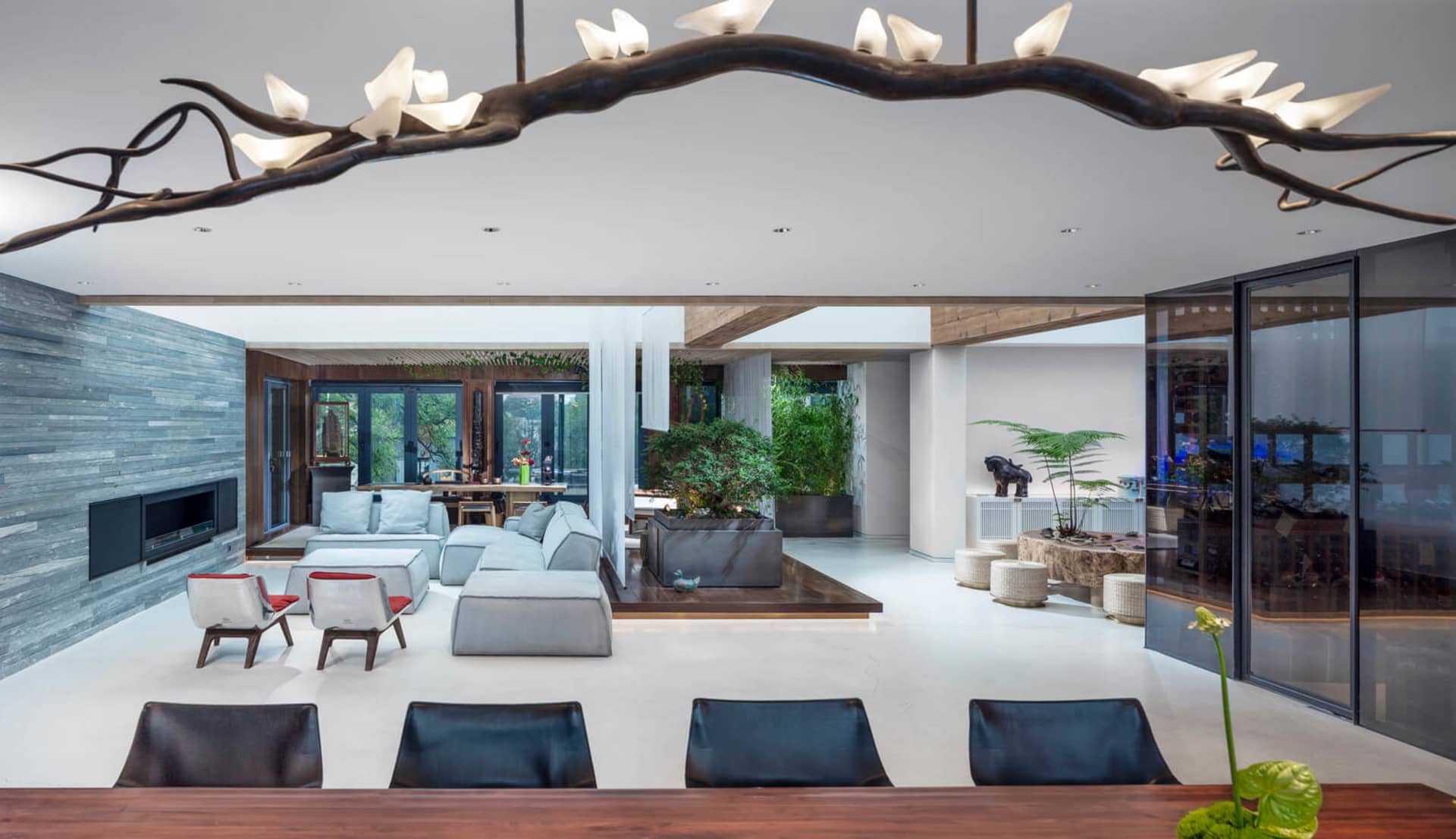 Modern living room featuring a concrete floor, contemporary furniture, and minimalist design elements.