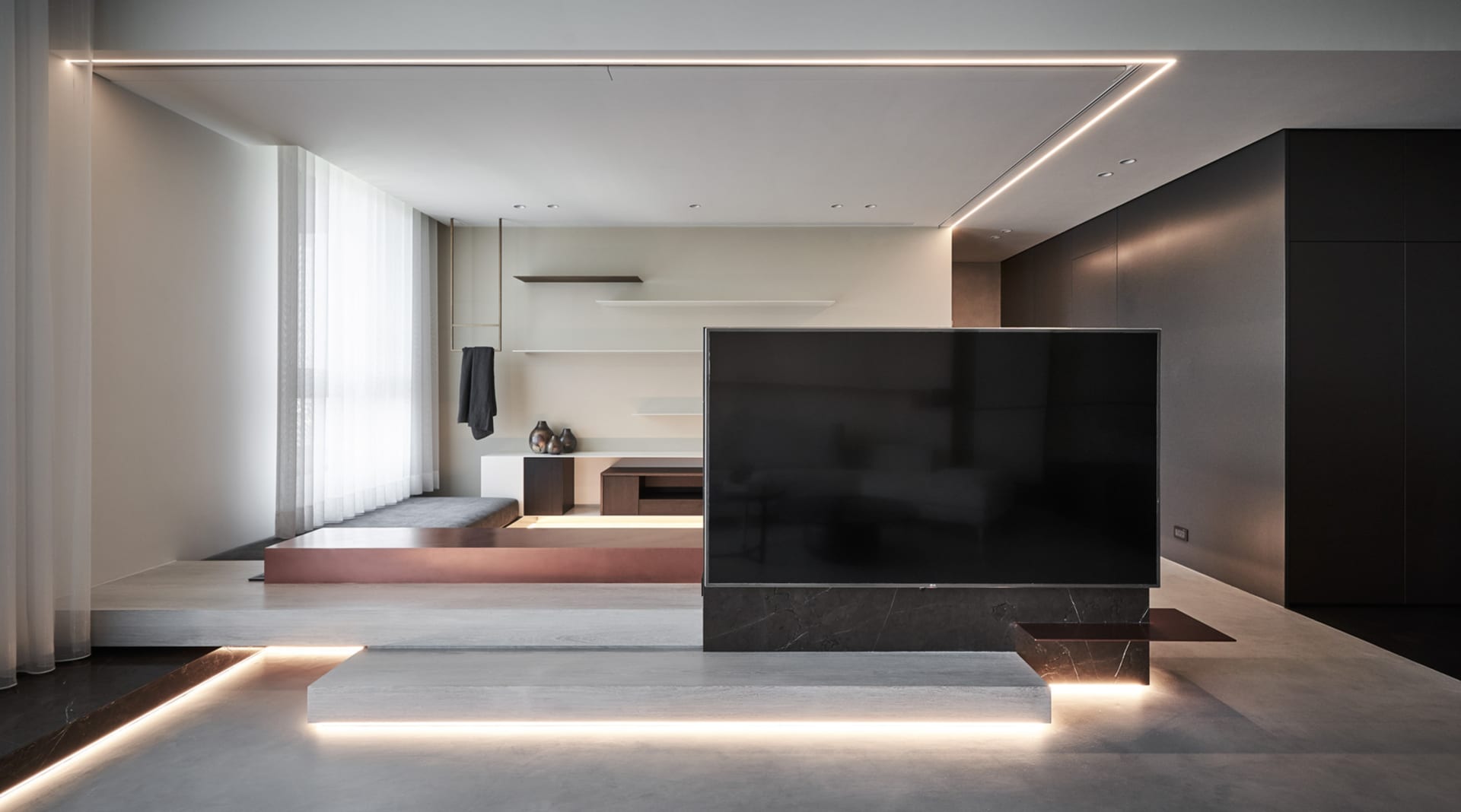 An image of a modern living room featuring a concrete floor and minimalist decor.