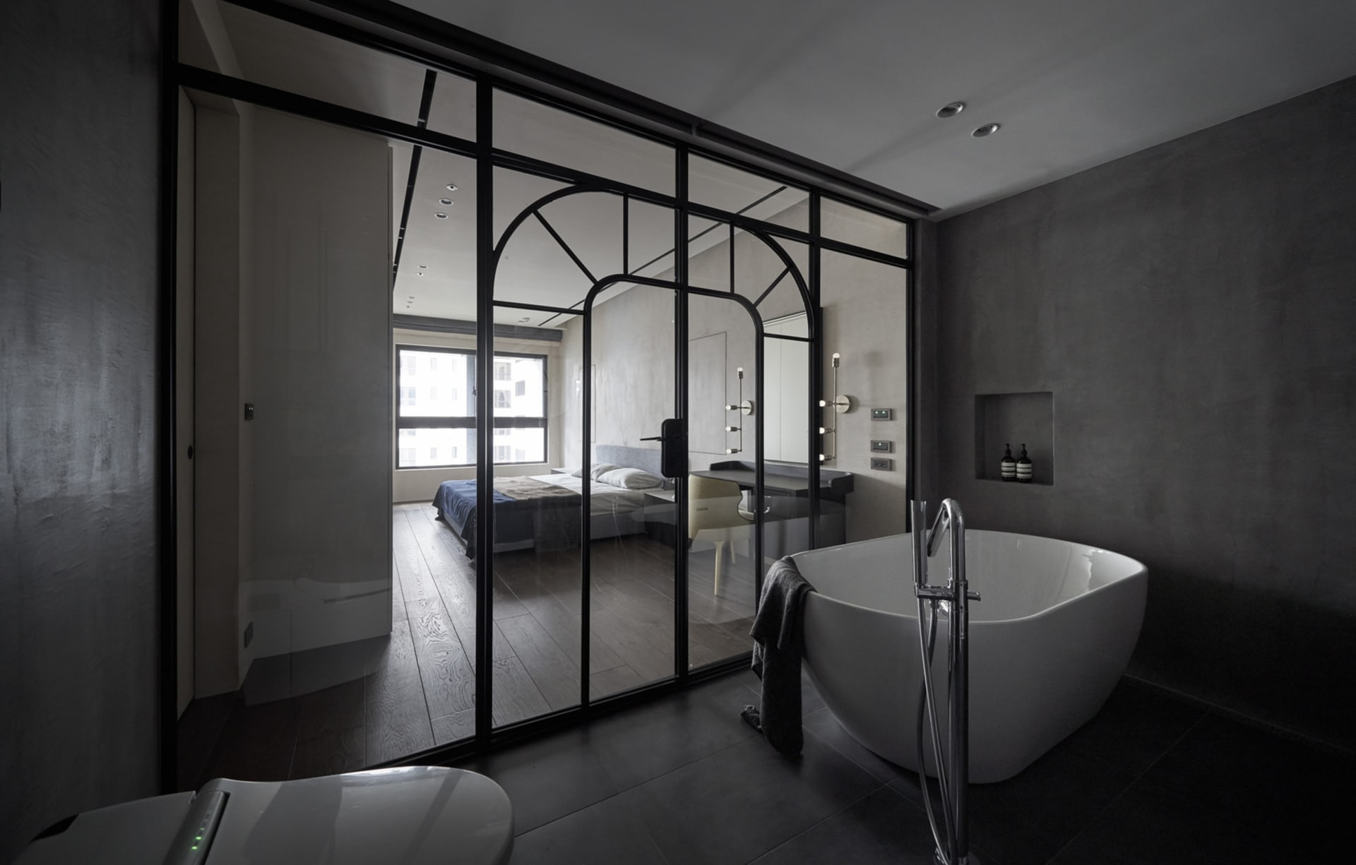 A modern residential bathroom with a concrete finish.