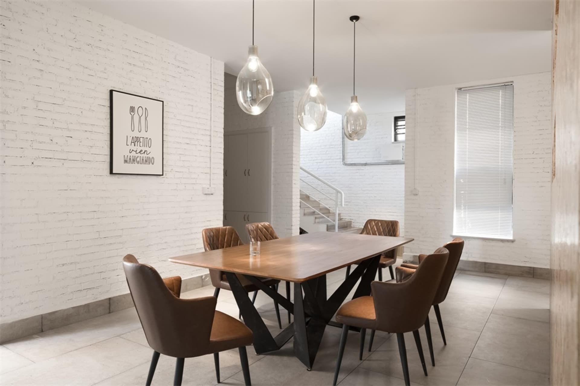 Modern industrial dining room with wooden furniture and white brick walls