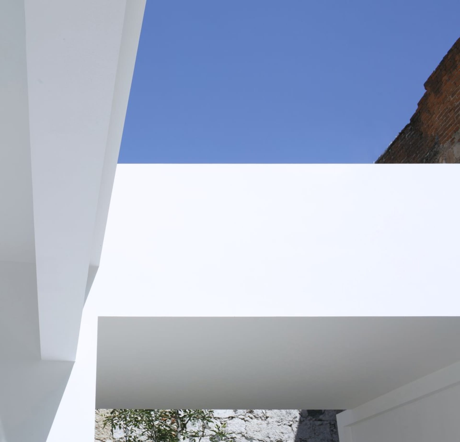 A minimalist architectural space featuring clean lines and glass elements.