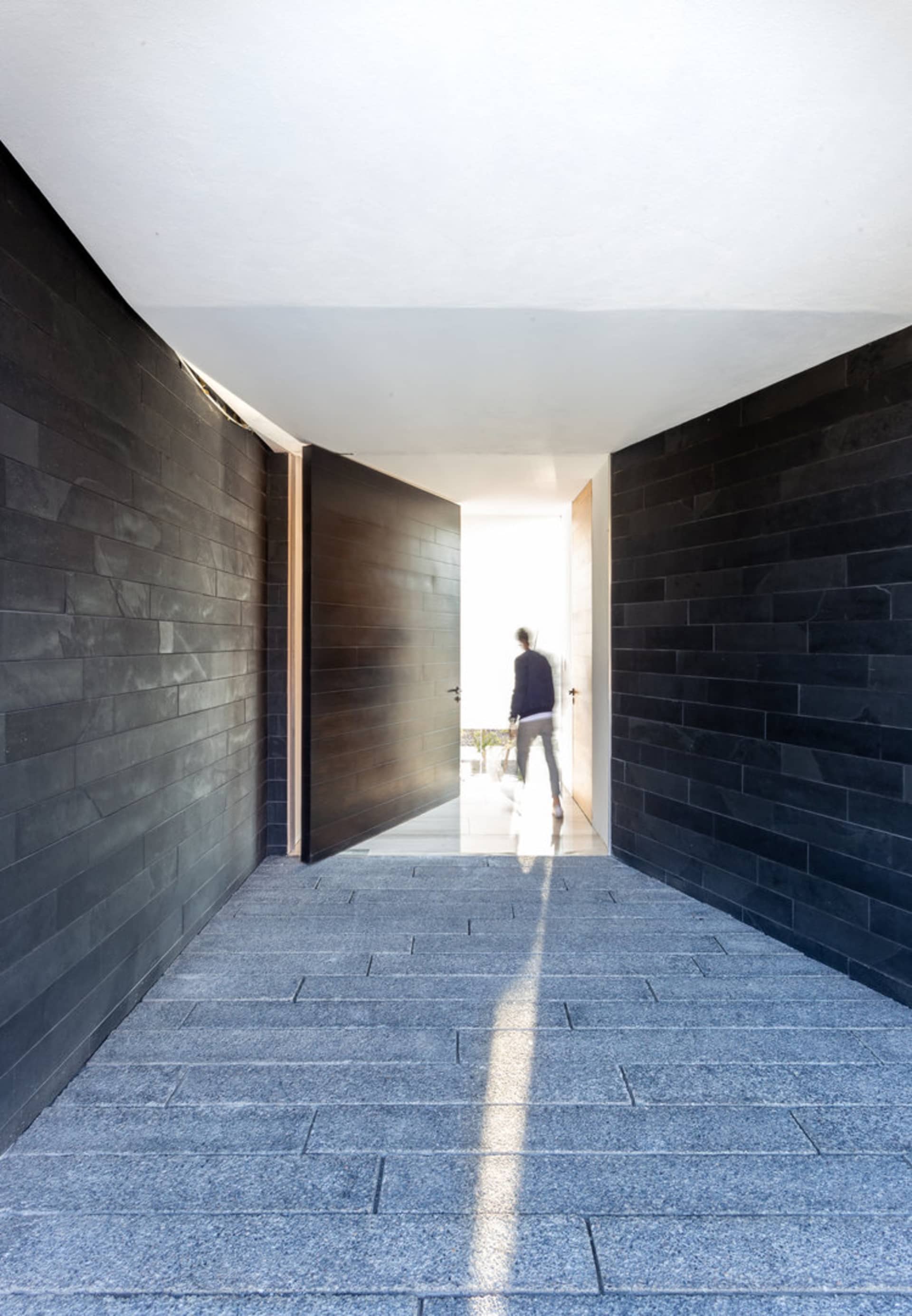 A modern pathway with concrete flooring and walls.