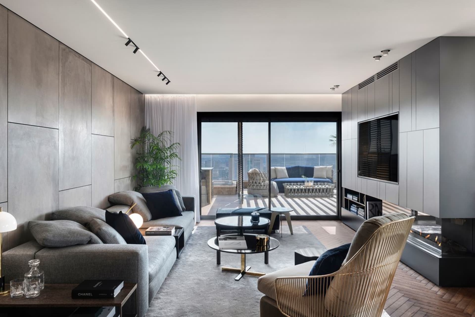 A modern living room featuring glass, metal, and wood elements.