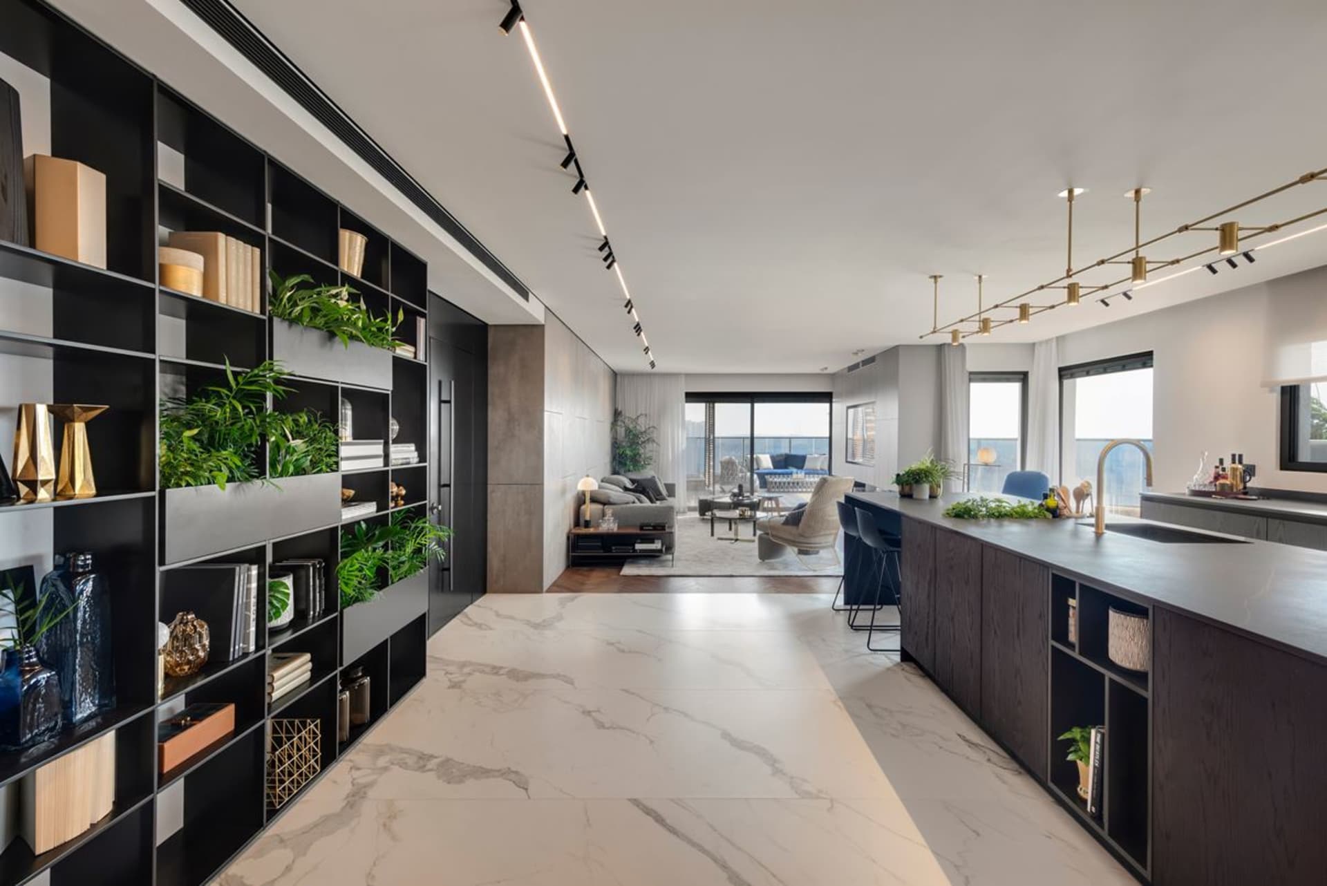 Modern living room and kitchen interior view featuring contemporary design elements.