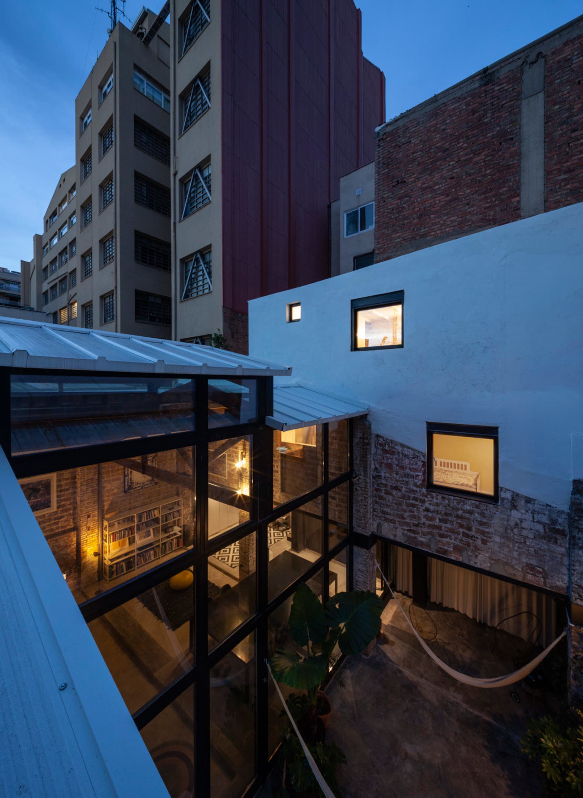 A renovated residential space with brick, concrete, and glass materials.